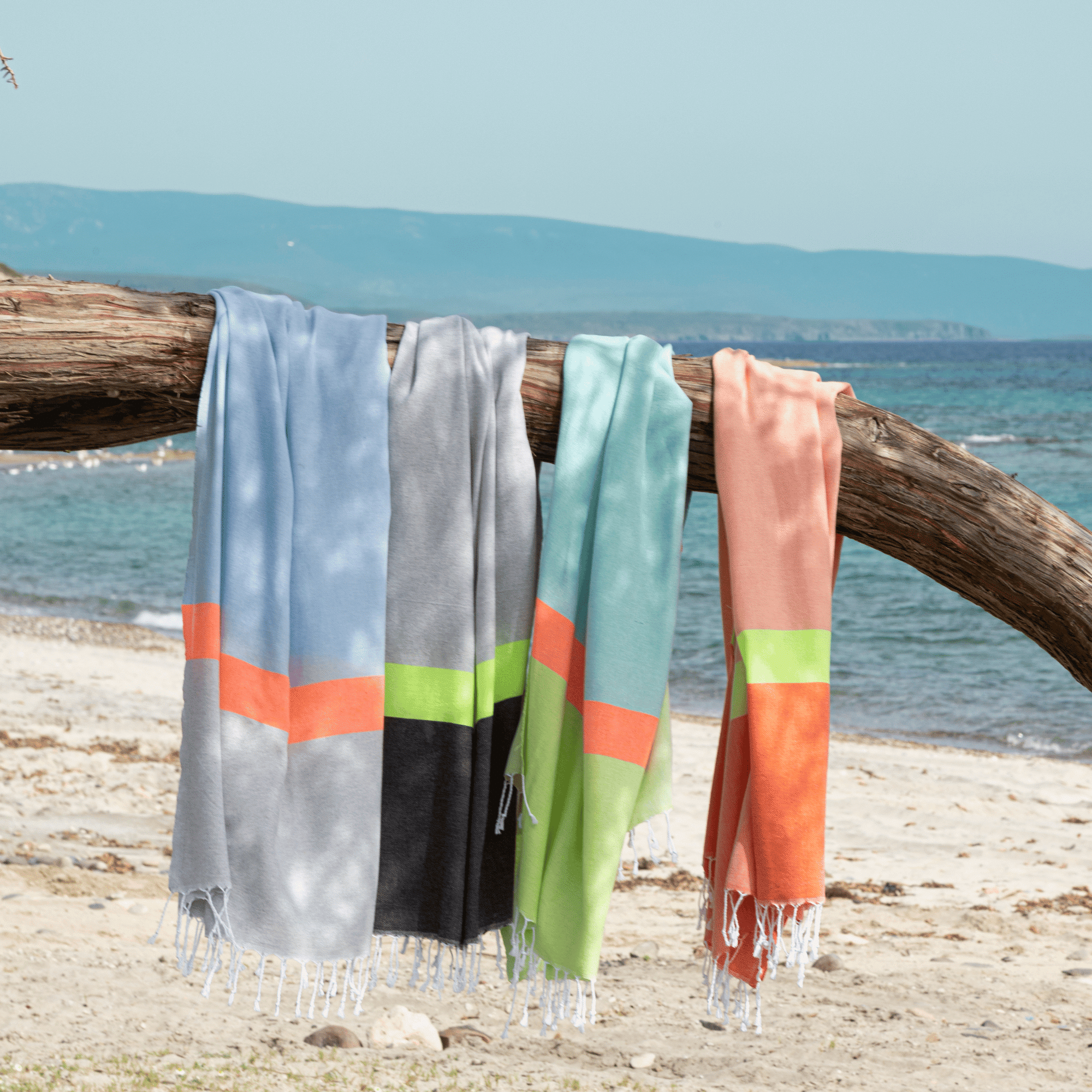 Neon Beach Towel in grey and black with neon stripe, displayed in a recycled gift box, showcasing eco-friendly design.