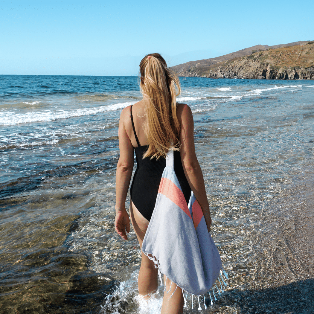 Neon Two-in-One Beach Towel and Bag in blue and grey, made from recycled cotton, showcasing its stylish design and functionality.