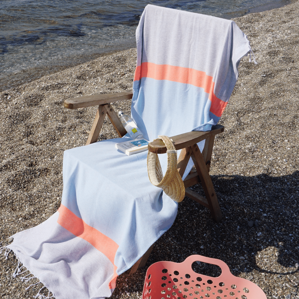 Neon Two-in-One Beach Towel and Bag in blue and grey, made from recycled cotton, showcasing its stylish design and functionality.