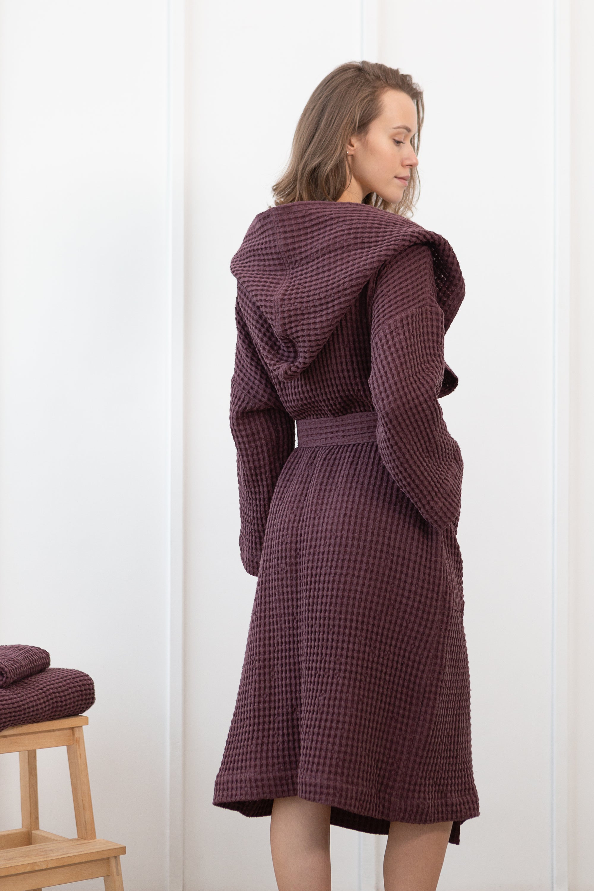 Plum linen waffle robe with a cozy hoodie, featuring a soft texture and two front pockets, perfect for relaxation.