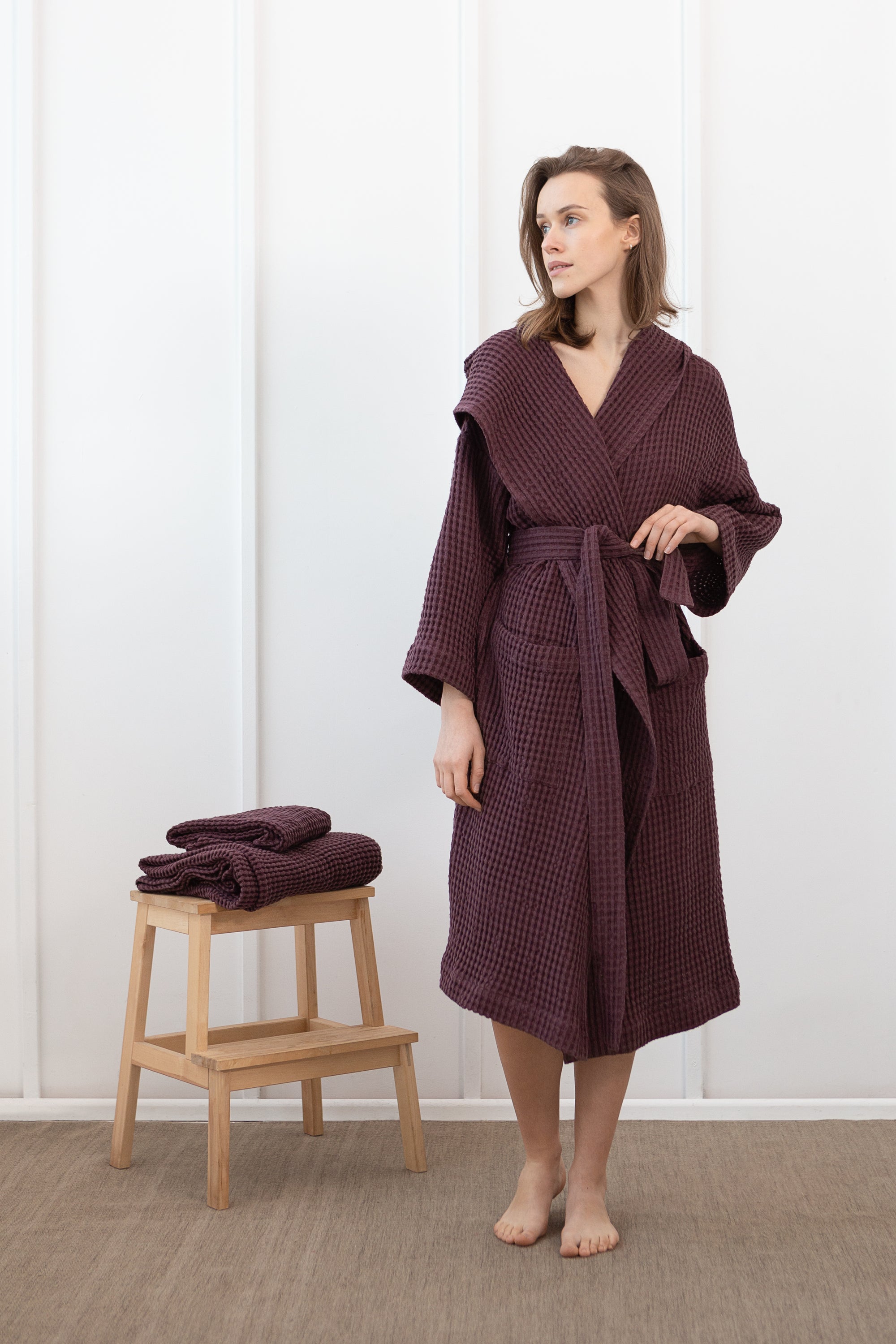 Plum linen waffle robe with a cozy hoodie, featuring a soft texture and two front pockets, perfect for relaxation.