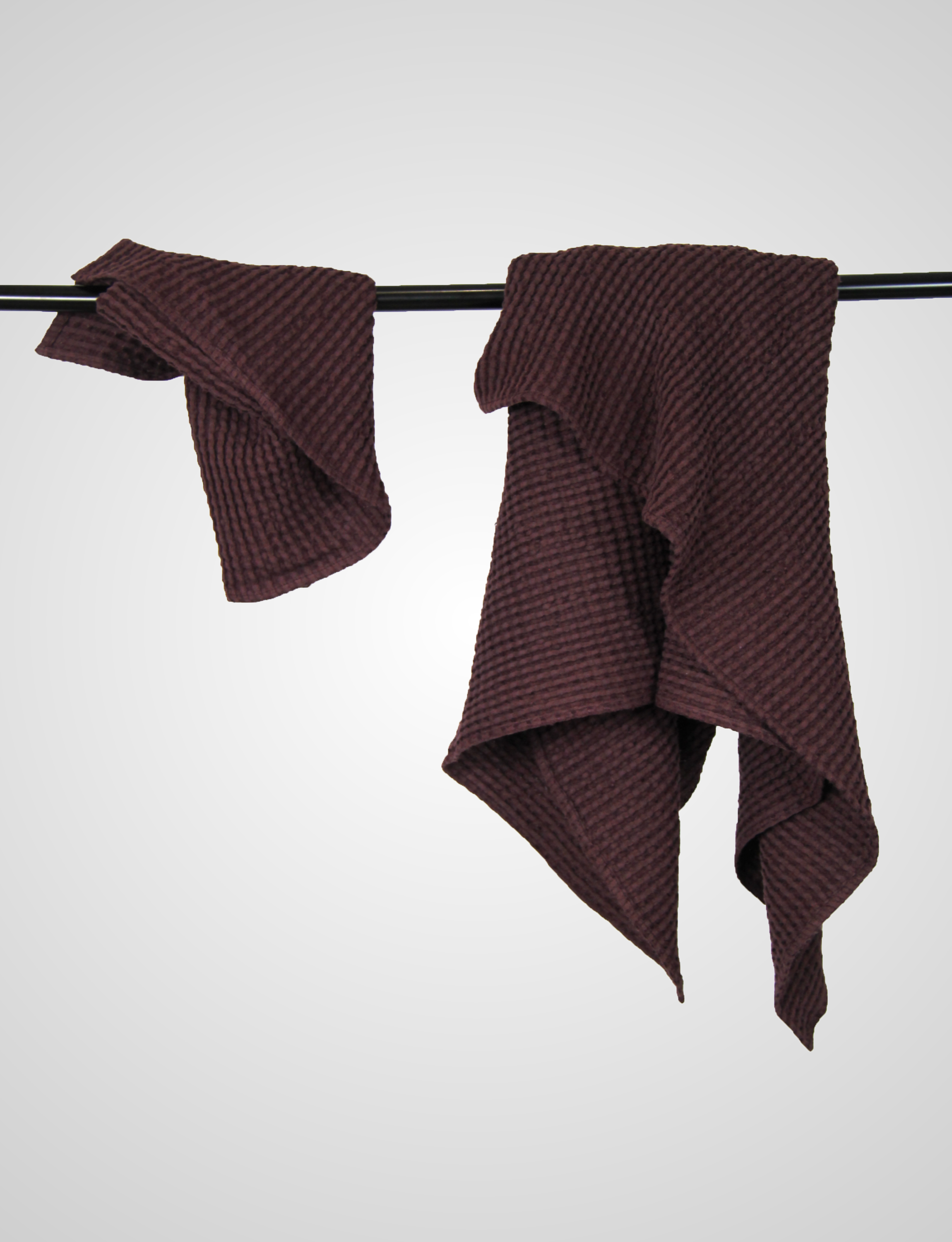 Luxurious plum linen waffle towel showcasing its unique texture and soft fabric, perfect for enhancing your bathing experience.