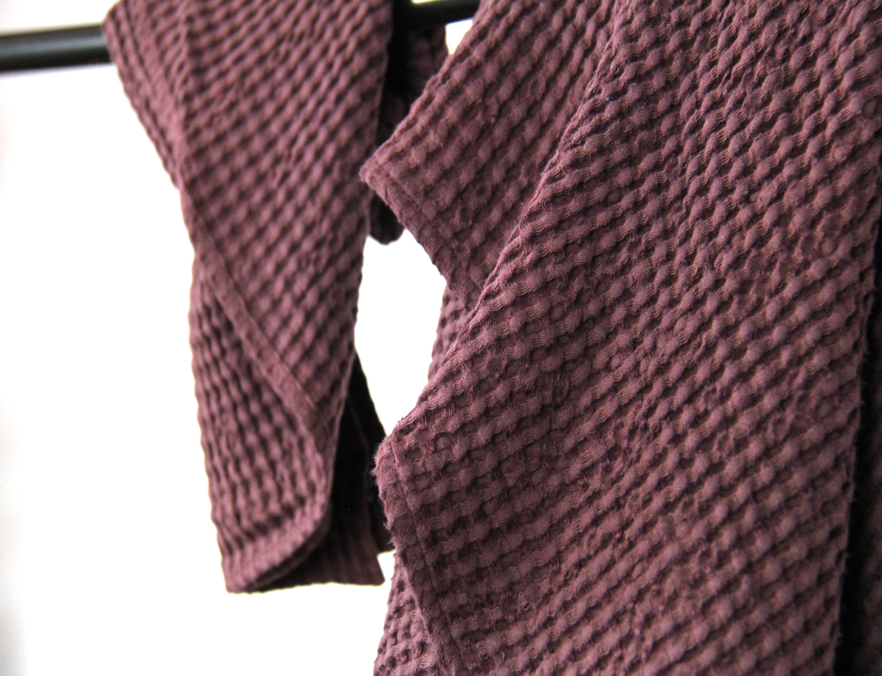 Luxurious plum linen waffle towel showcasing its unique texture and soft fabric, perfect for enhancing your bathing experience.