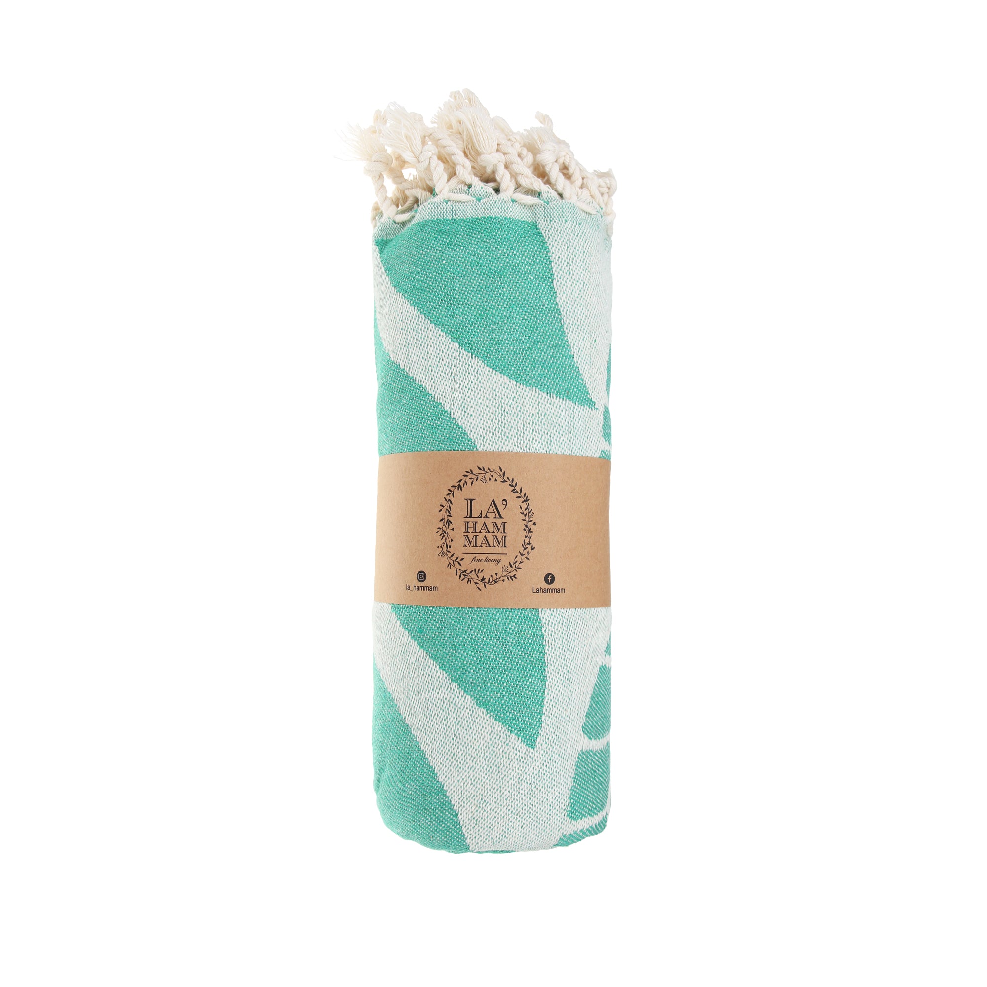 A vibrant Seaweed Pure Cotton Throw Beach Towel displayed on a sandy beach, showcasing its soft texture and traditional woven design.