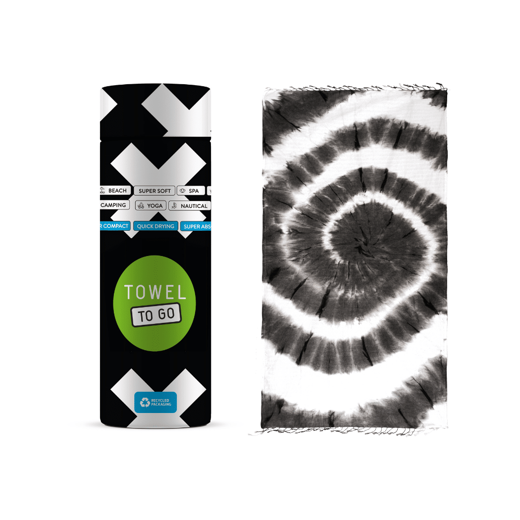 A vibrant tie-dye beach towel in black and white, elegantly displayed in a recycled gift box, showcasing its unique patterns and eco-friendly design.