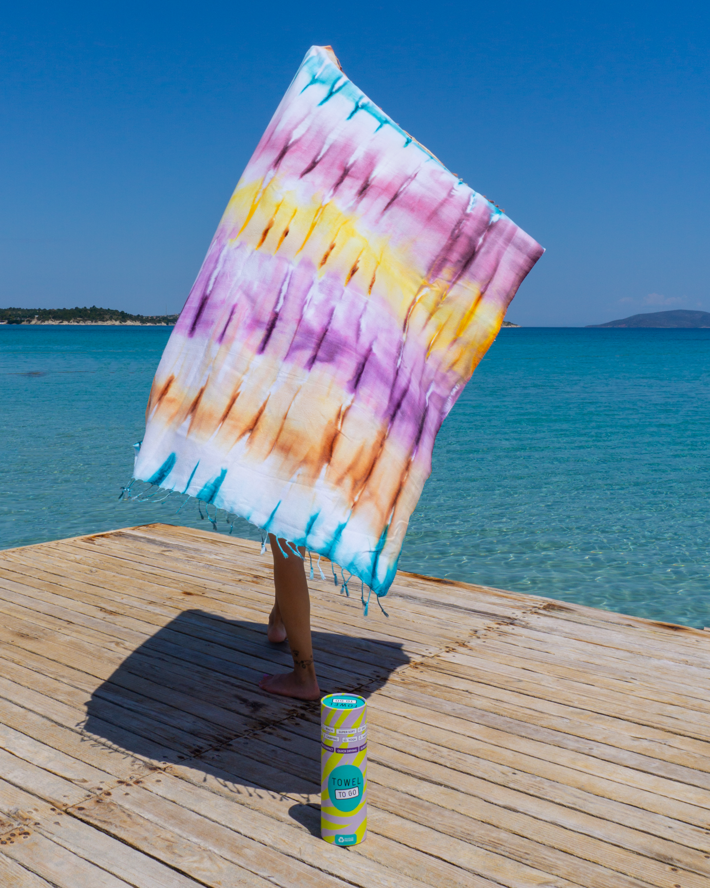 A vibrant purple and blue tie-dye convertible towel kimono, showcasing its stylish design and eco-friendly fabric, perfect for beach outings.