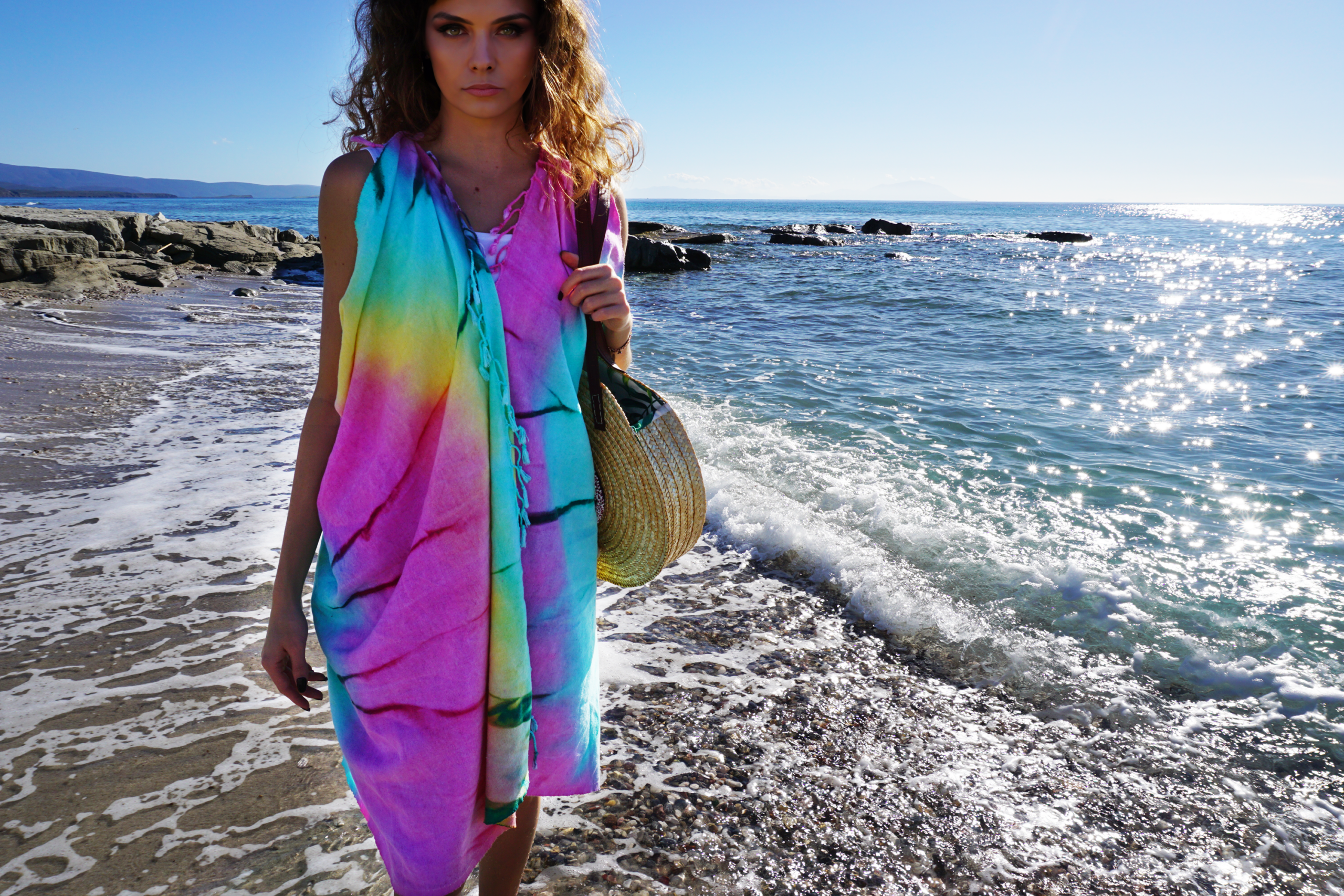 A vibrant purple and blue tie-dye convertible towel kimono, showcasing its stylish design and eco-friendly fabric, perfect for beach outings.