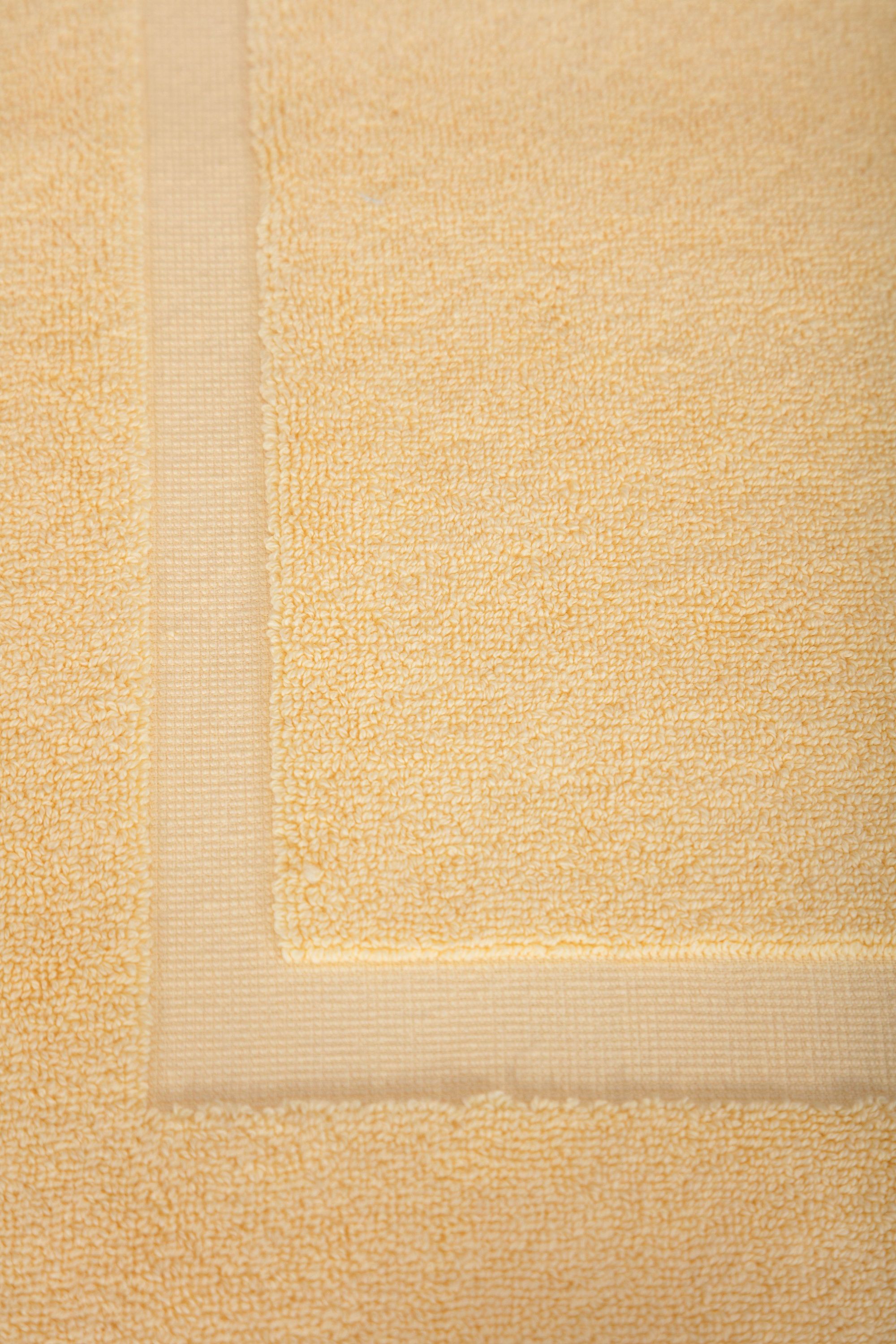 Two luxurious Turkish cotton bath mats in a stylish design, showcasing their plush texture and dobby weave border.