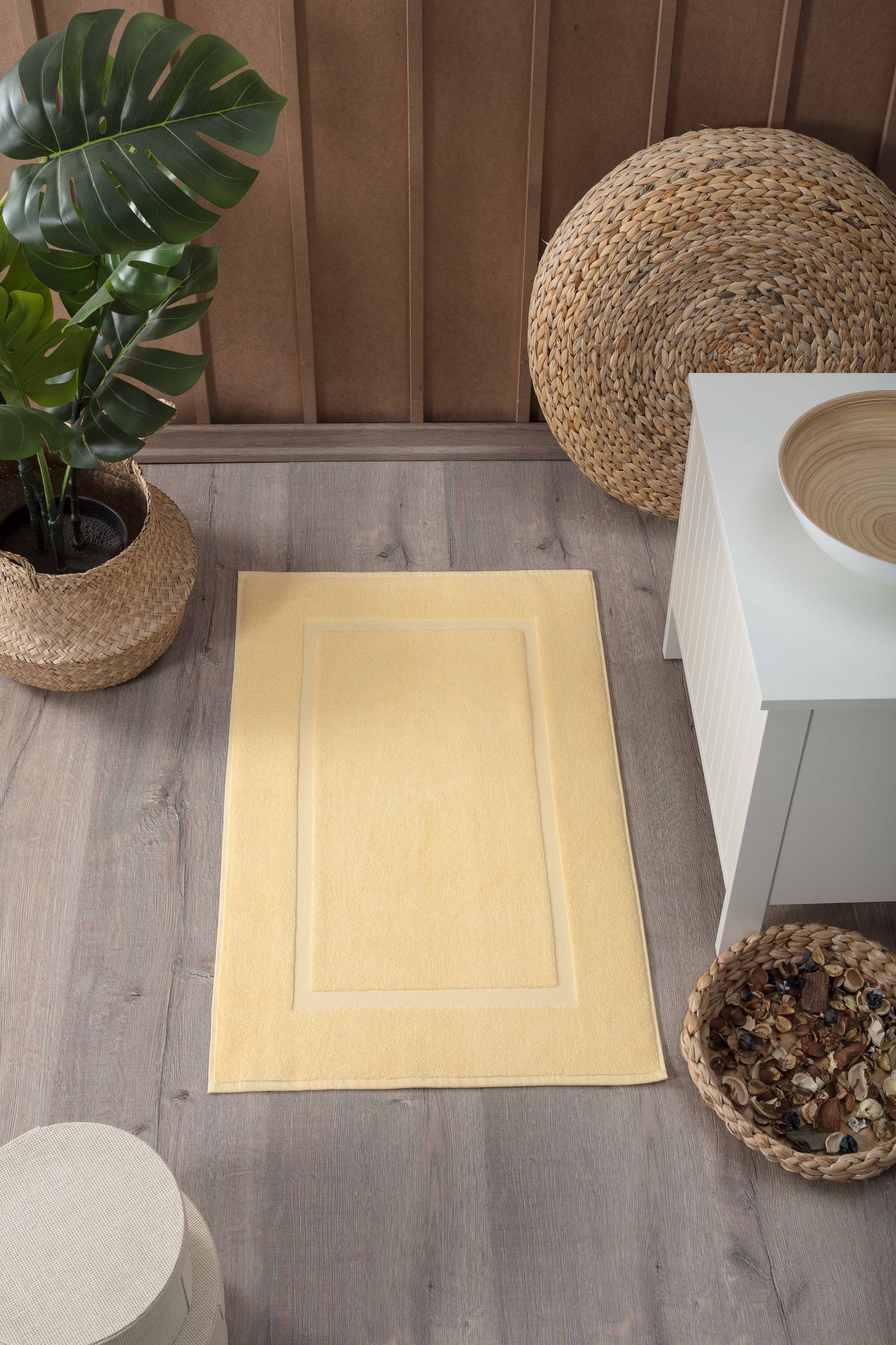 Two luxurious Turkish cotton bath mats in a stylish design, showcasing their plush texture and dobby weave border.