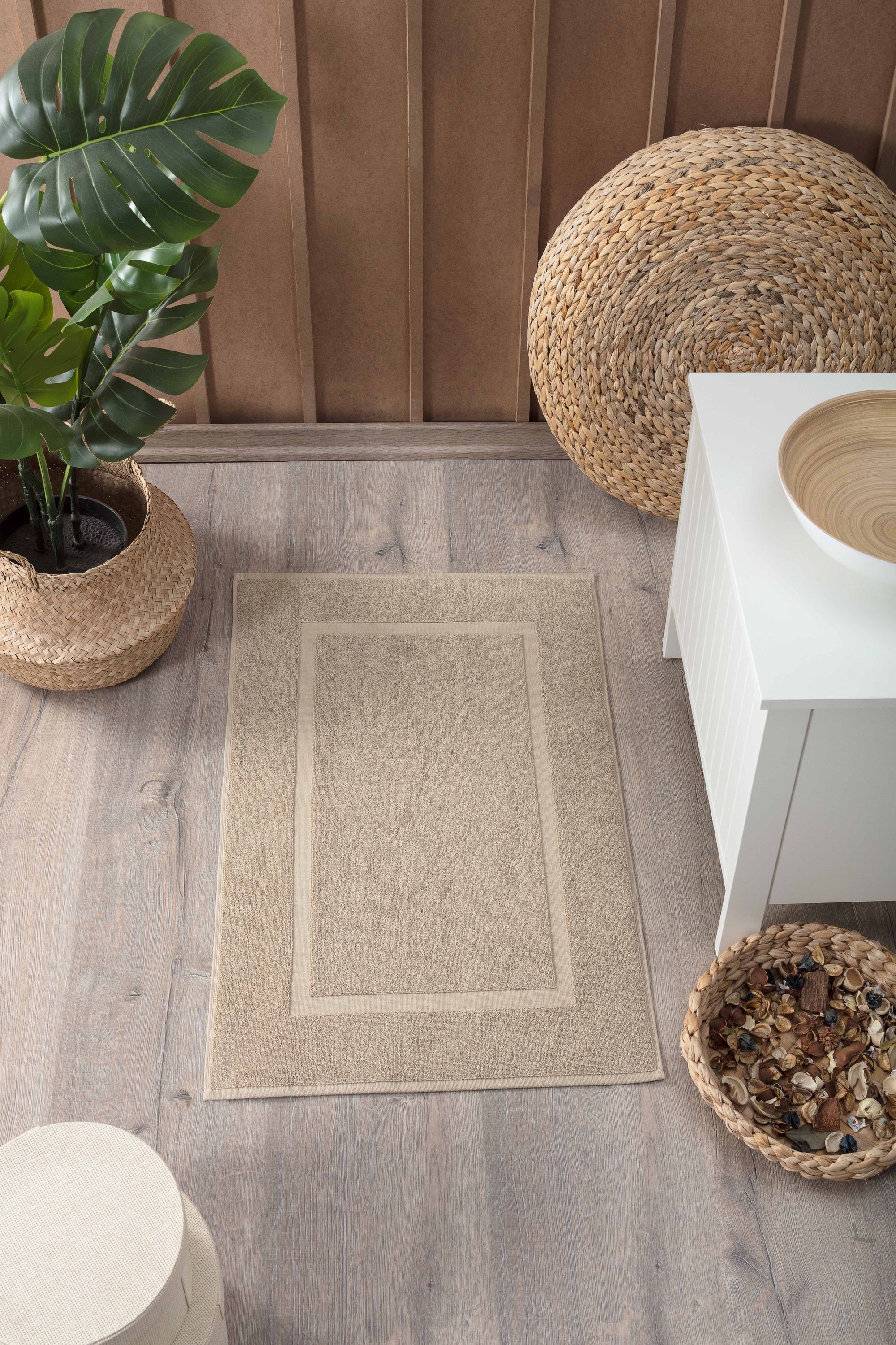 Two luxurious Turkish cotton bath mats in a stylish design, showcasing their plush texture and dobby weave border.