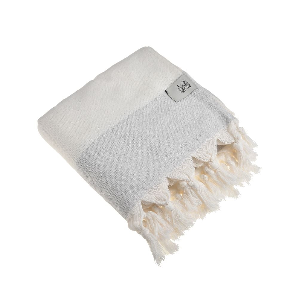 Violet Beach Towel made of soft Turkish cotton with white fringes, perfect for beach or home use.