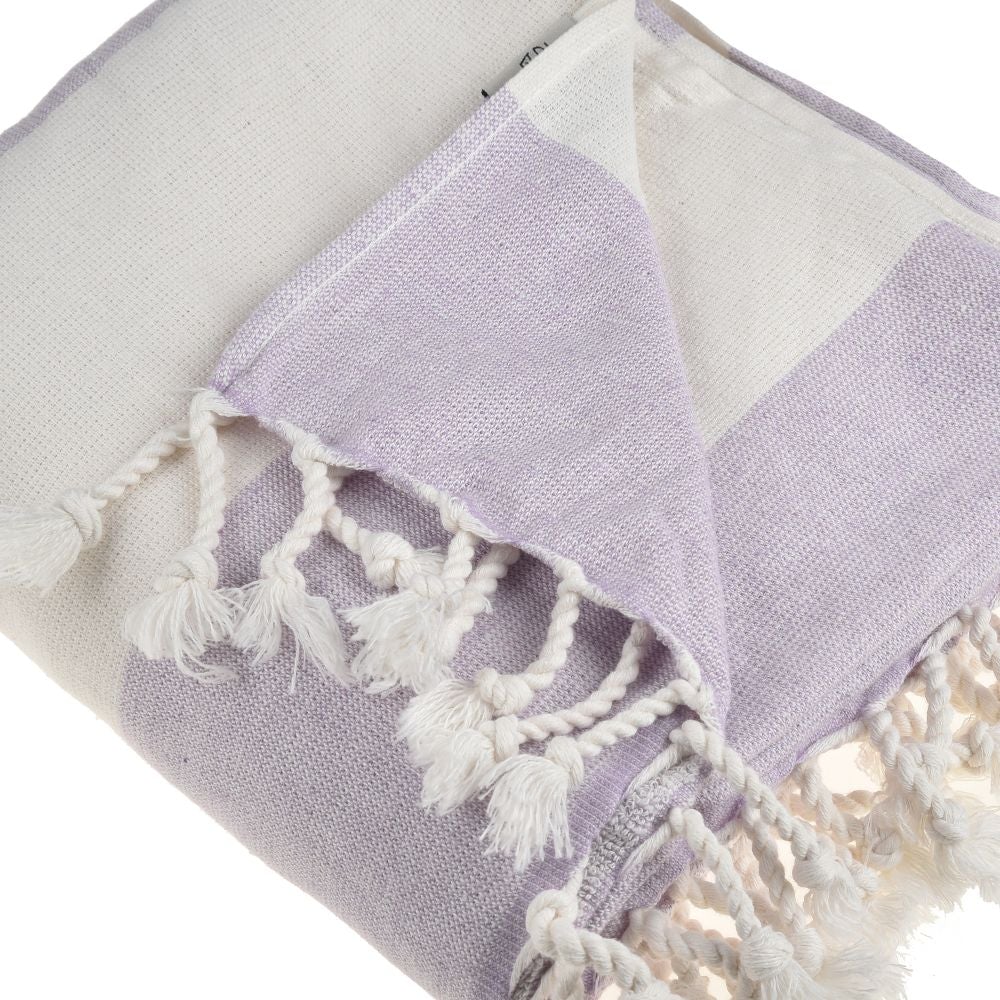 Violet Beach Towel made of soft Turkish cotton with white fringes, perfect for beach or home use.