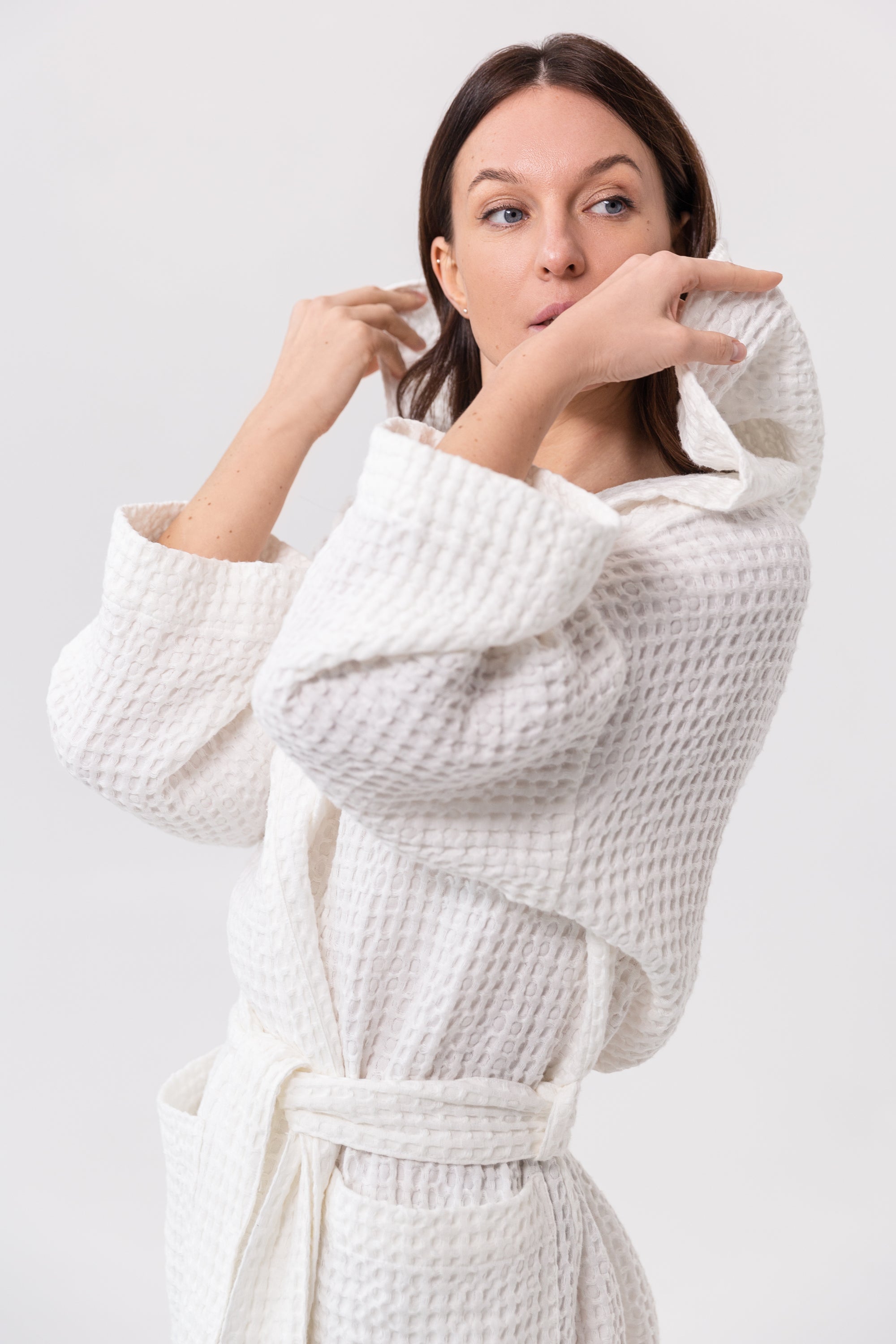 White linen waffle robe with a cozy hoodie, featuring a soft texture and two front pockets, perfect for relaxation.