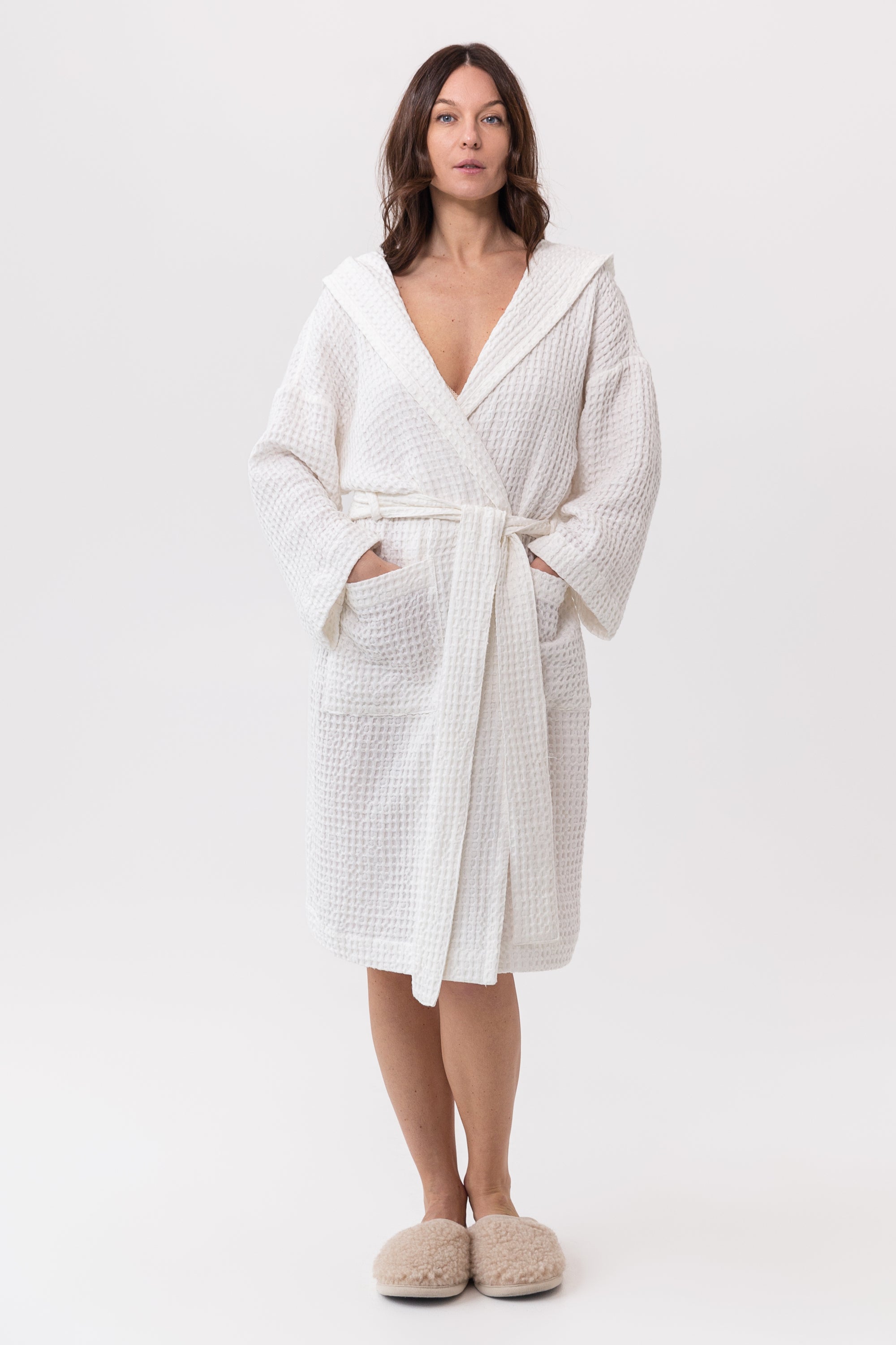 White linen waffle robe with a cozy hoodie, featuring a soft texture and two front pockets, perfect for relaxation.