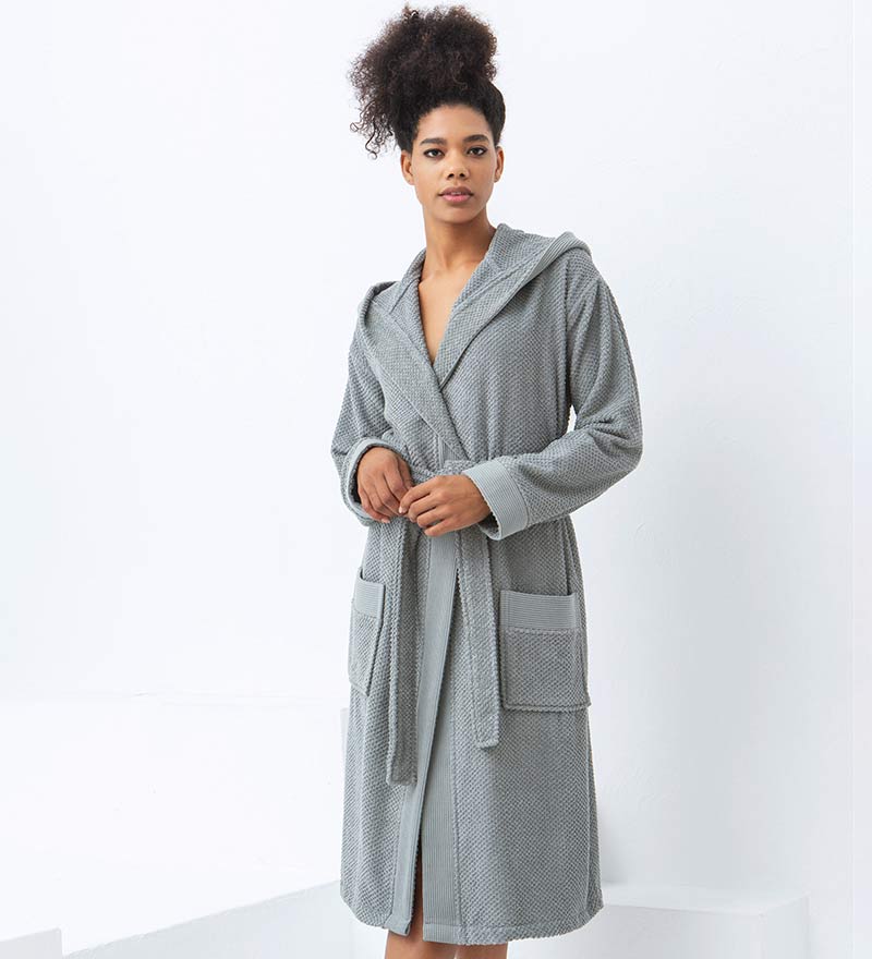 A luxurious Women's Hooded Turkish Cotton Terry Cloth Robe in calming colors, featuring a soft hood, large pockets, and a stylish belt.