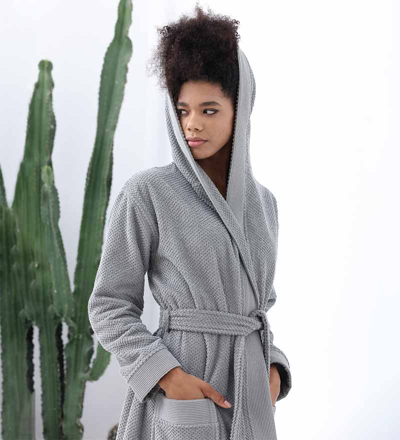 A luxurious Women's Hooded Turkish Cotton Terry Cloth Robe in calming colors, featuring a soft hood, large pockets, and a stylish belt.