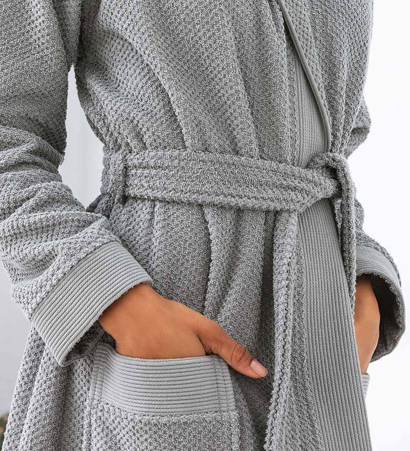 A luxurious Women's Hooded Turkish Cotton Terry Cloth Robe in calming colors, featuring a soft hood, large pockets, and a stylish belt.