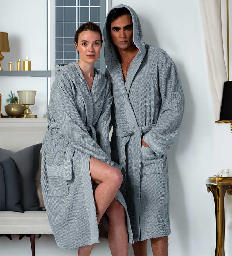 A luxurious Women's Hooded Turkish Cotton Terry Cloth Robe in calming colors, featuring a soft hood, large pockets, and a stylish belt.