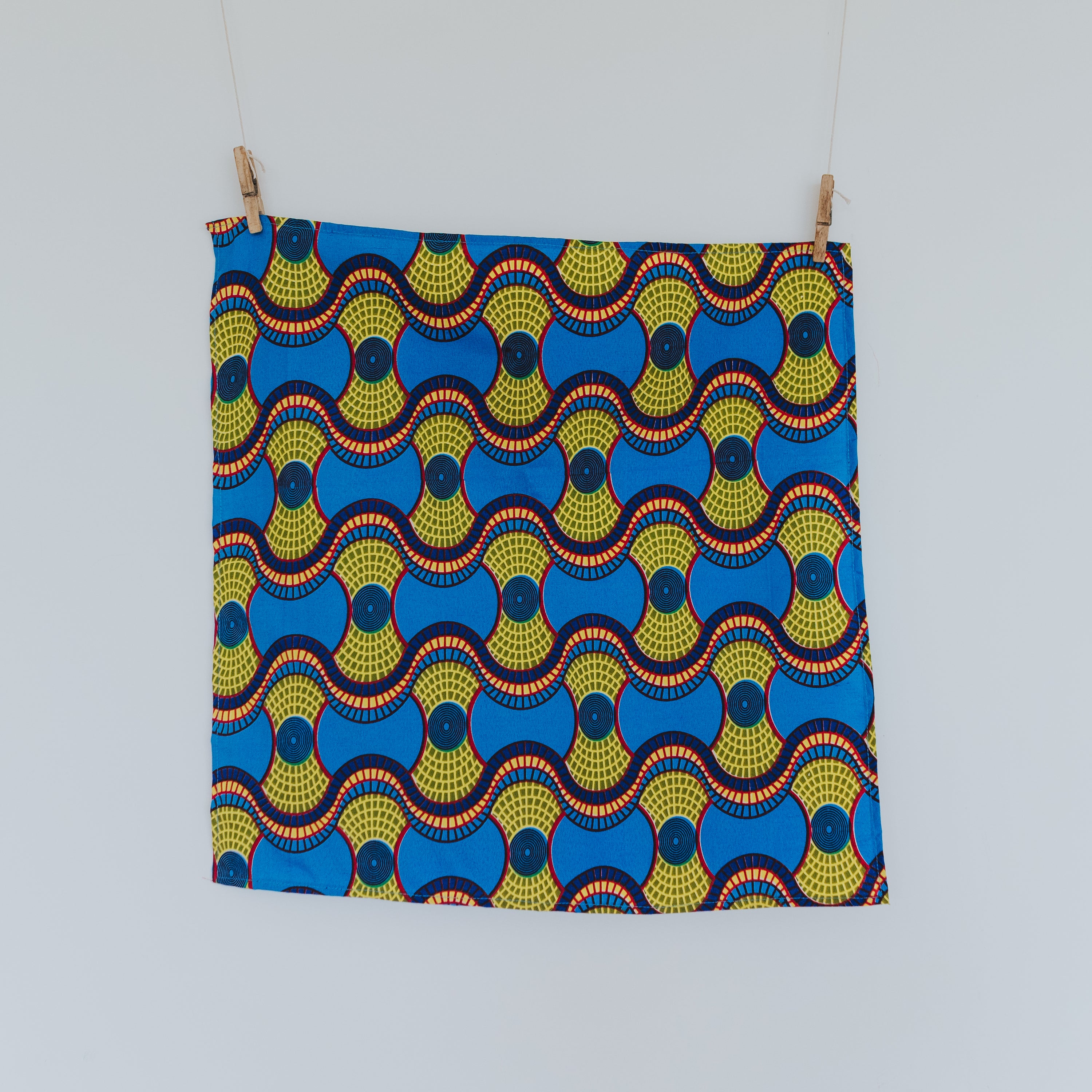 Two vibrant Furoshiki inspired Ankara Gift Wraps showcasing intricate patterns, perfect for eco-friendly gifting.