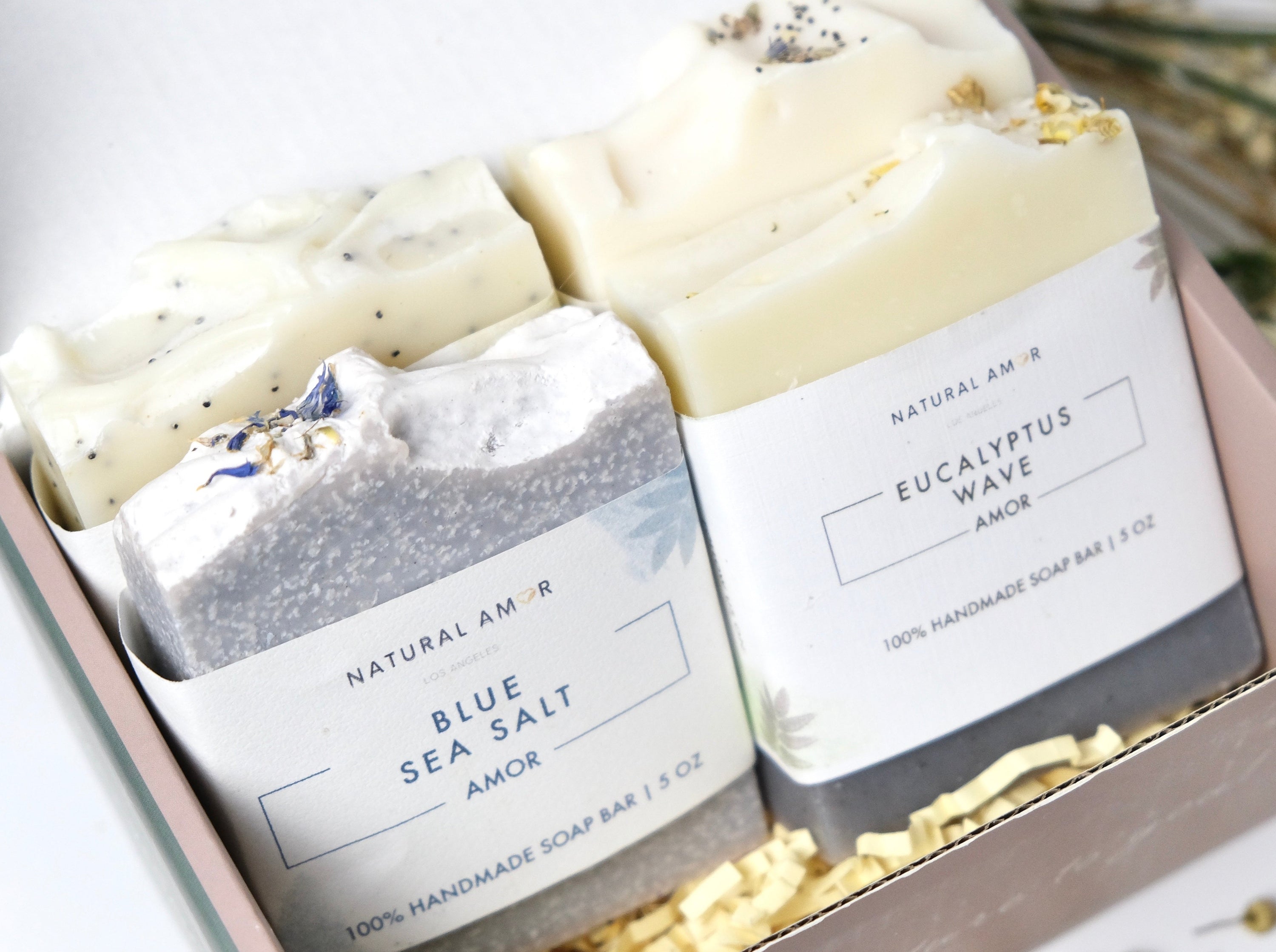 A beautifully arranged 4pk Handmade Soap Gift Box featuring various colorful soap bars in elegant packaging.