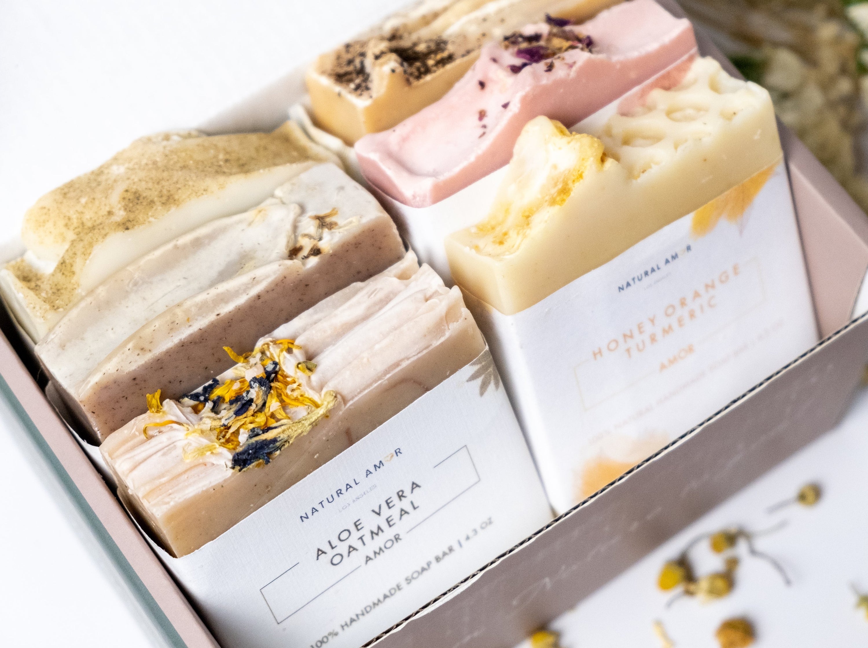 A beautifully arranged 6pk handmade soap gift box featuring various artisan soap bars with natural ingredients and essential oils.