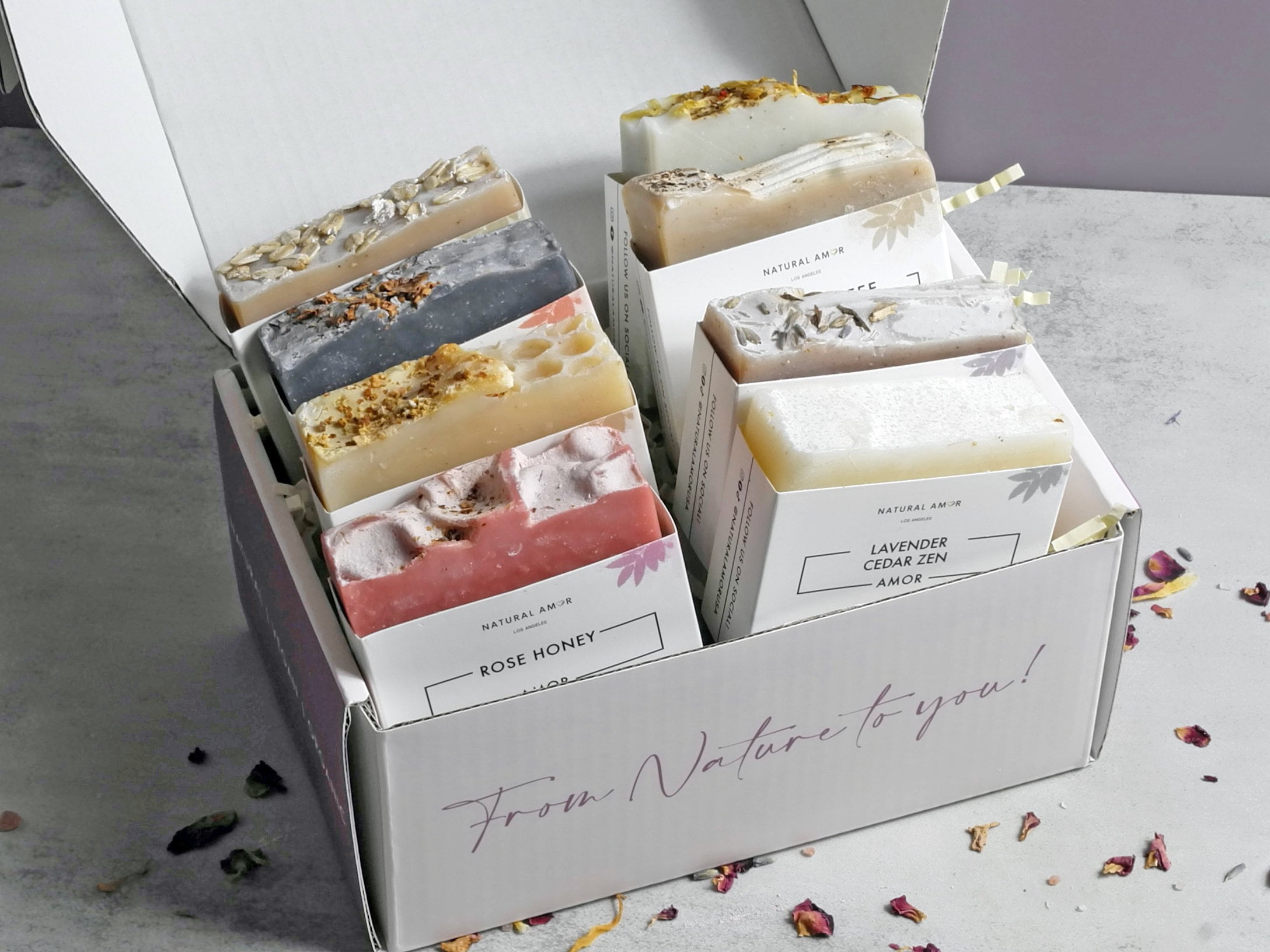 A beautifully arranged 8pk Handmade Soap Gift Box featuring various colorful soap bars, showcasing natural ingredients and elegant packaging.