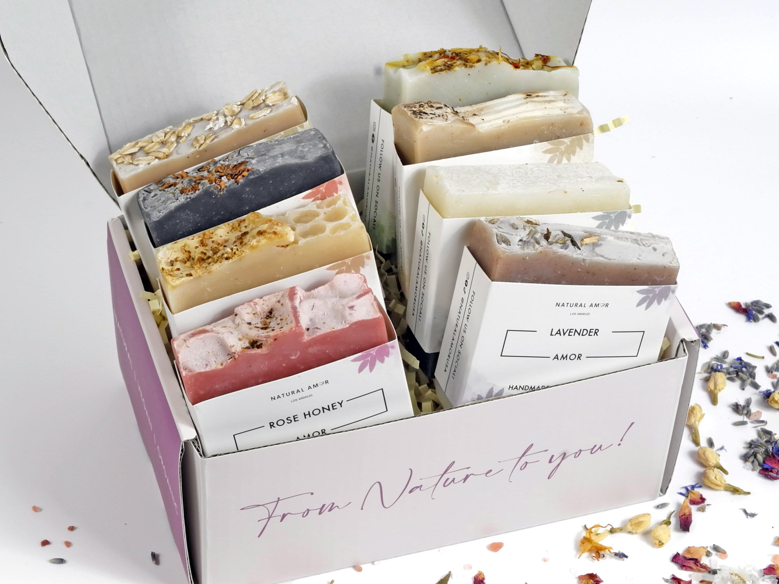 A beautifully arranged 8pk Handmade Soap Gift Box featuring various colorful soap bars, showcasing natural ingredients and elegant packaging.