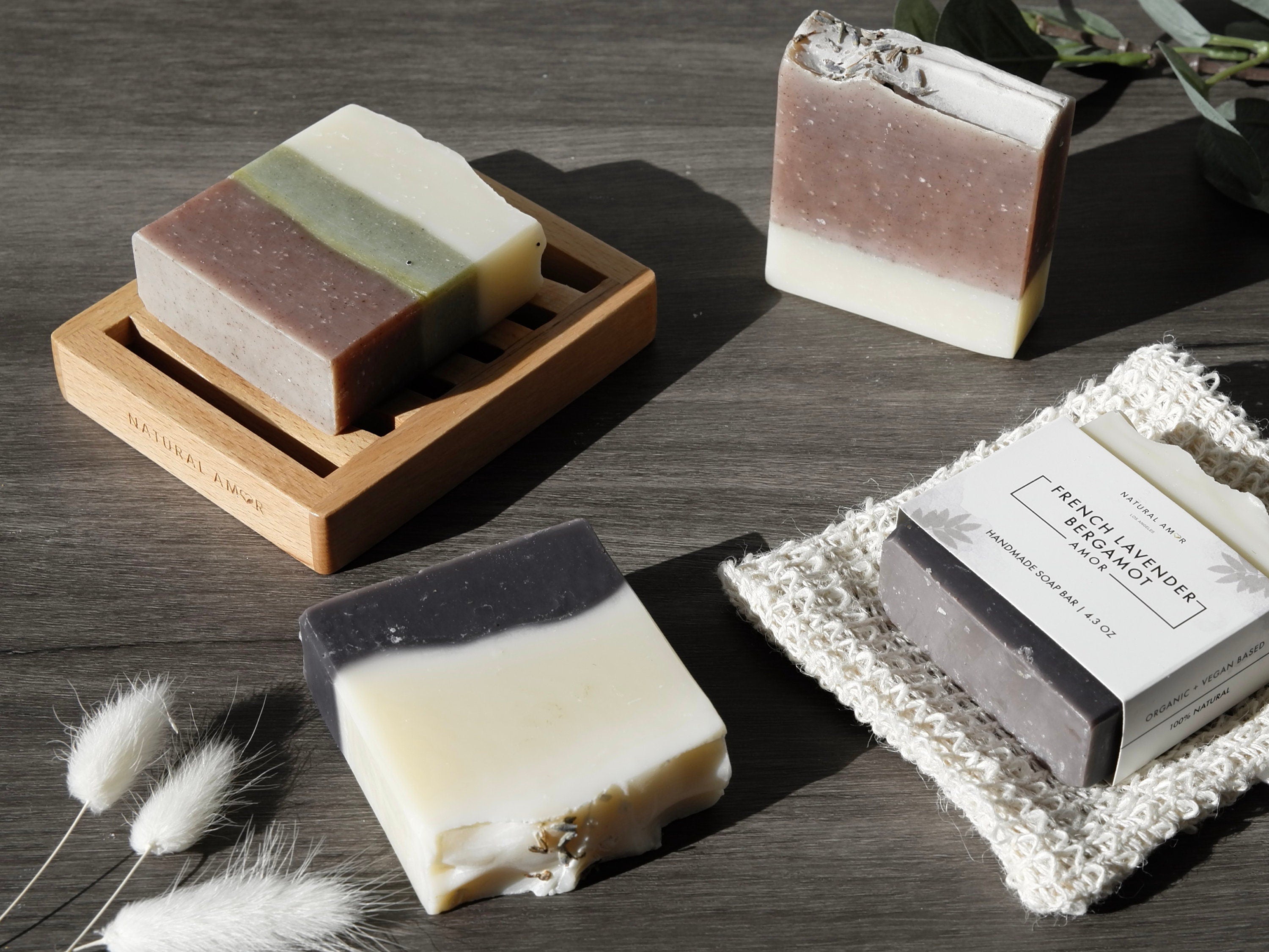 A beautifully arranged 8pk Handmade Soap Gift Box featuring various colorful soap bars, showcasing natural ingredients and elegant packaging.