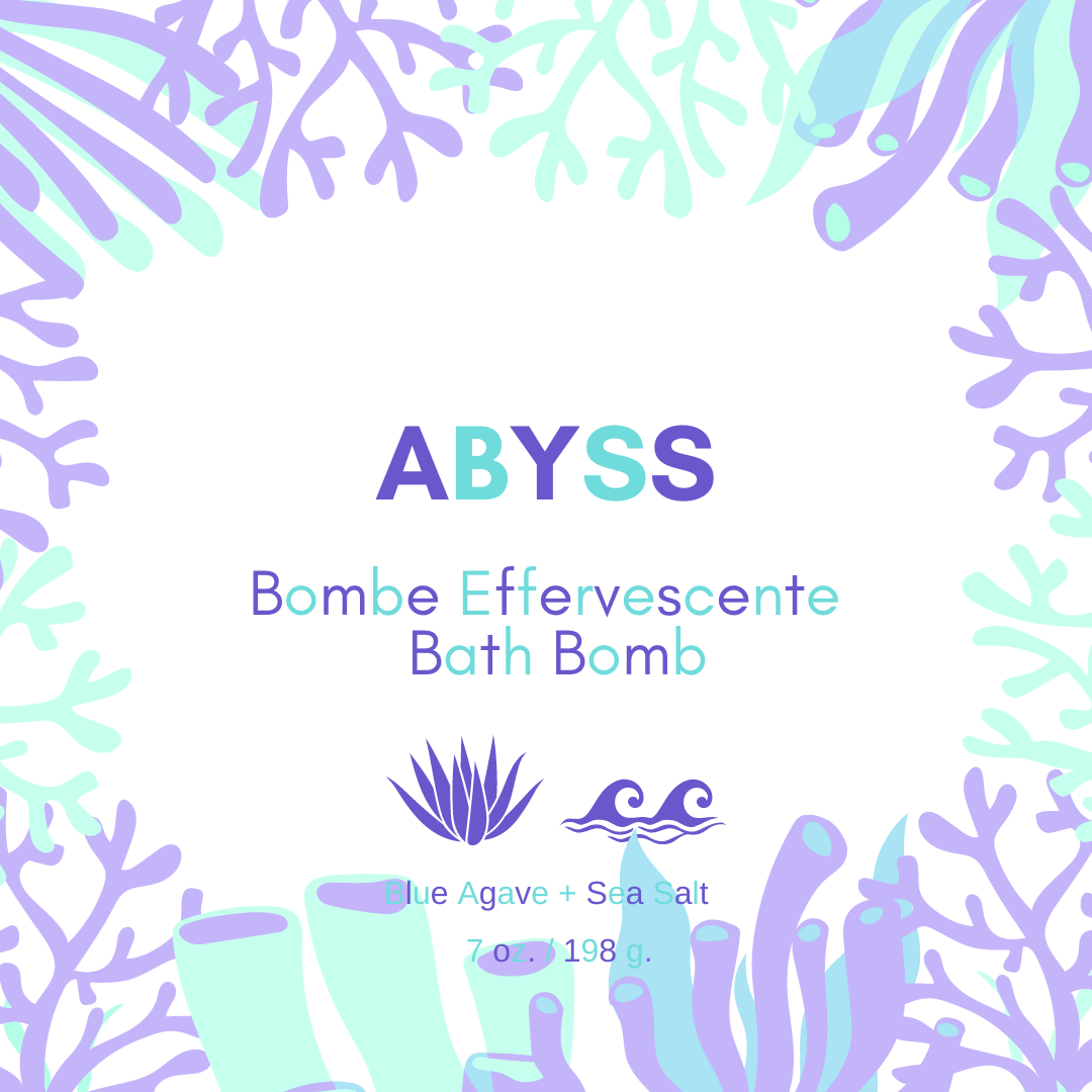 Abyss Bath Bomb in vibrant colors, featuring Blue Agave and Sea Salt scent, resting on a wooden surface with bubbles around it.