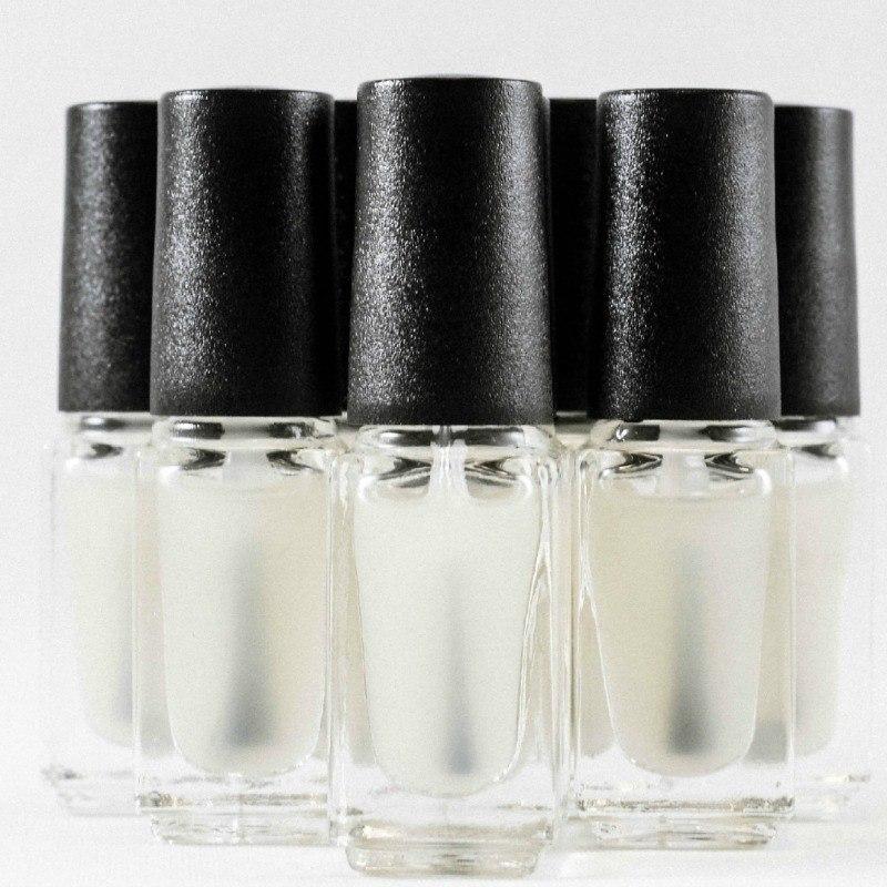 Set of 5 smart-sized nail polish bottles with agitator balls, showcasing their sleek design and clear glass.