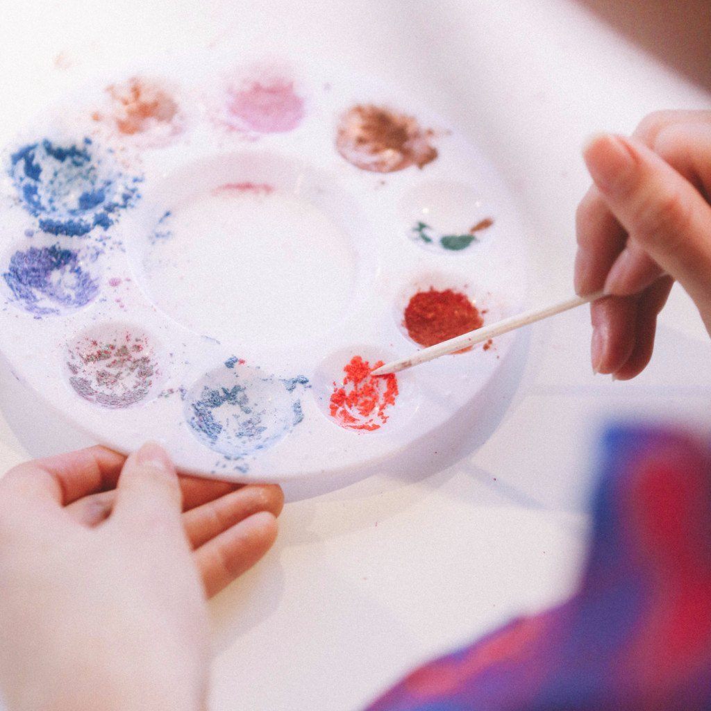 A vibrant selection of nail polish colors arranged in a palette, showcasing various shades for custom nail polish creation.