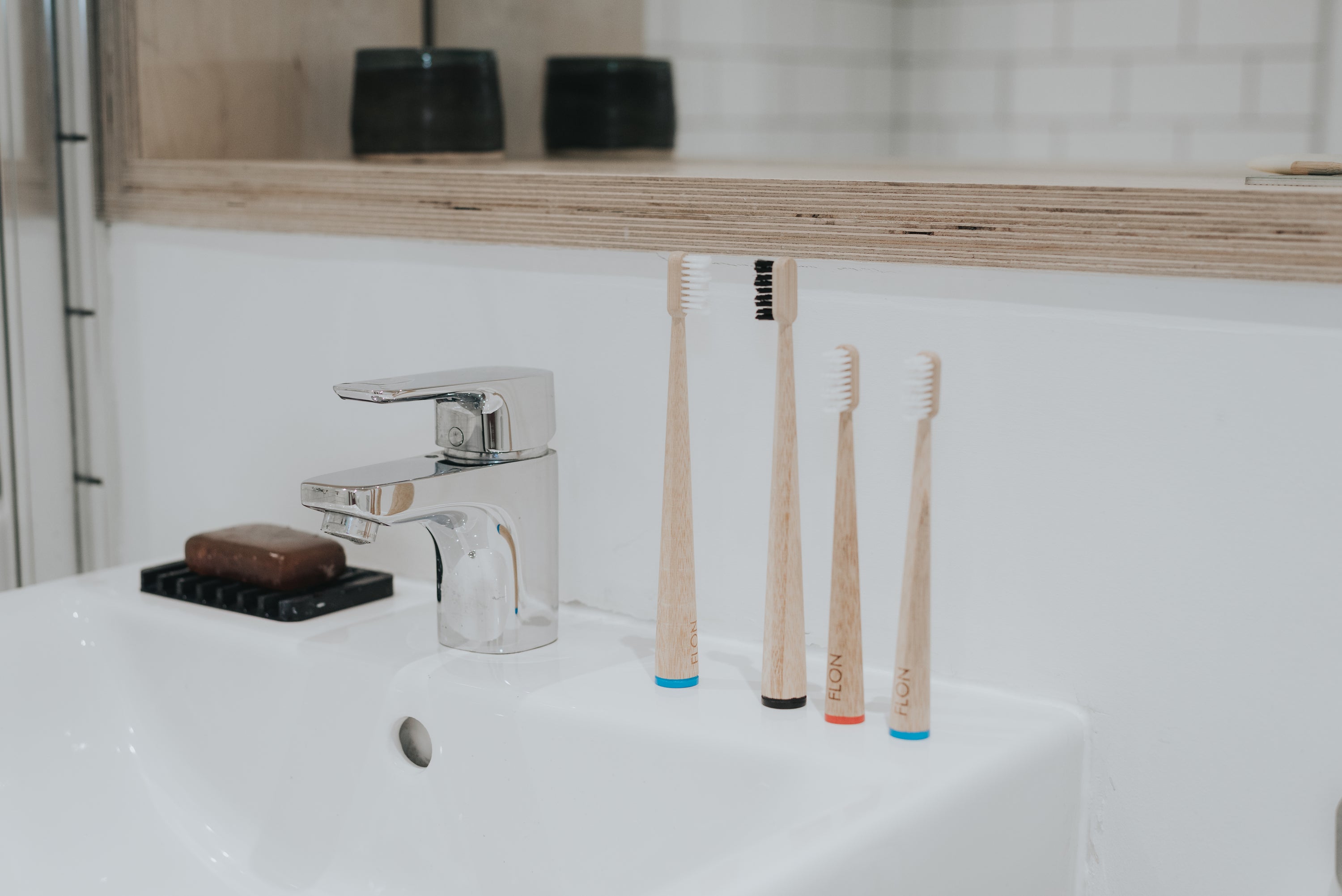 FLON Adult Bamboo Toothbrush with biodegradable bamboo handle and non-BPA bristles, showcasing eco-friendly design.