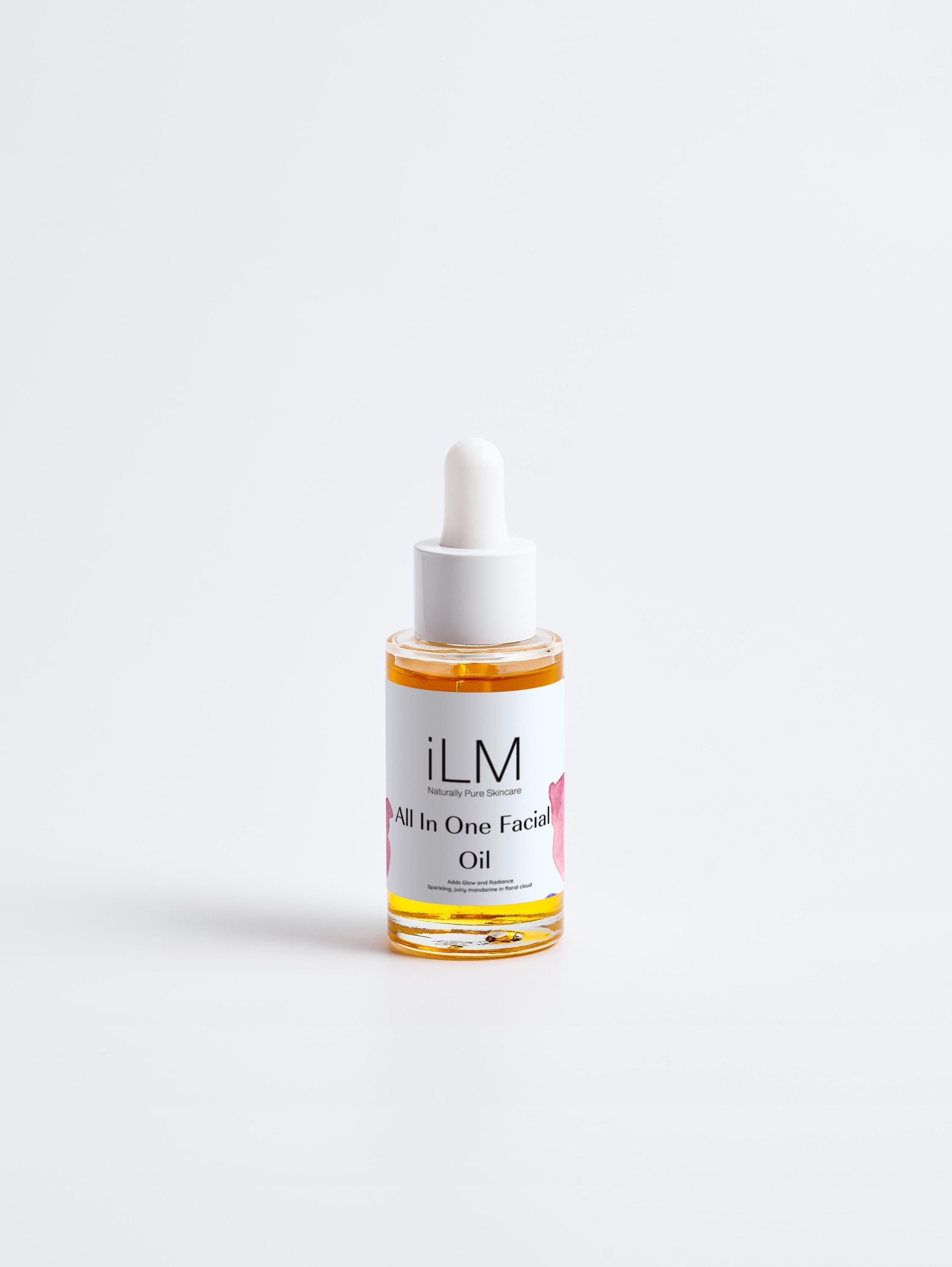 A bottle of all-in-one facial oil with a dropper, showcasing its rich, golden color and elegant packaging, surrounded by natural ingredients like jojoba seeds and avocados.