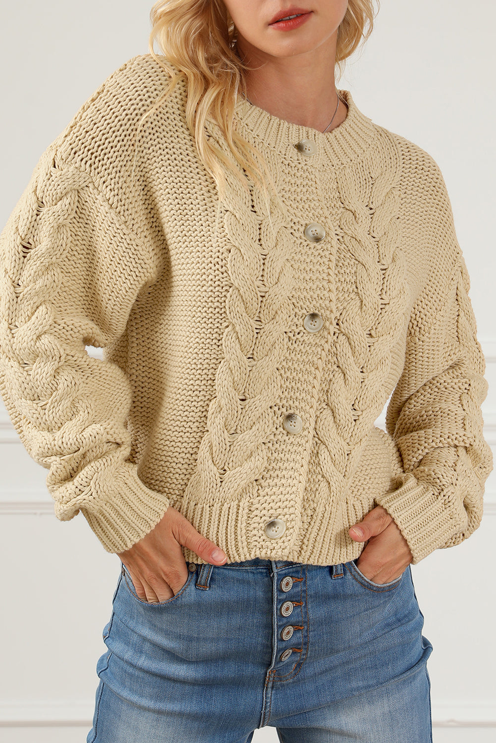 Apricot Cable Knit Buttoned Cardigan featuring a classic round neck, buttoned front, and cozy knit texture, perfect for cold weather styling.