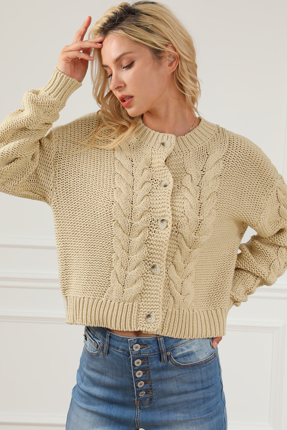 Apricot Cable Knit Buttoned Cardigan featuring a classic round neck, buttoned front, and cozy knit texture, perfect for cold weather styling.