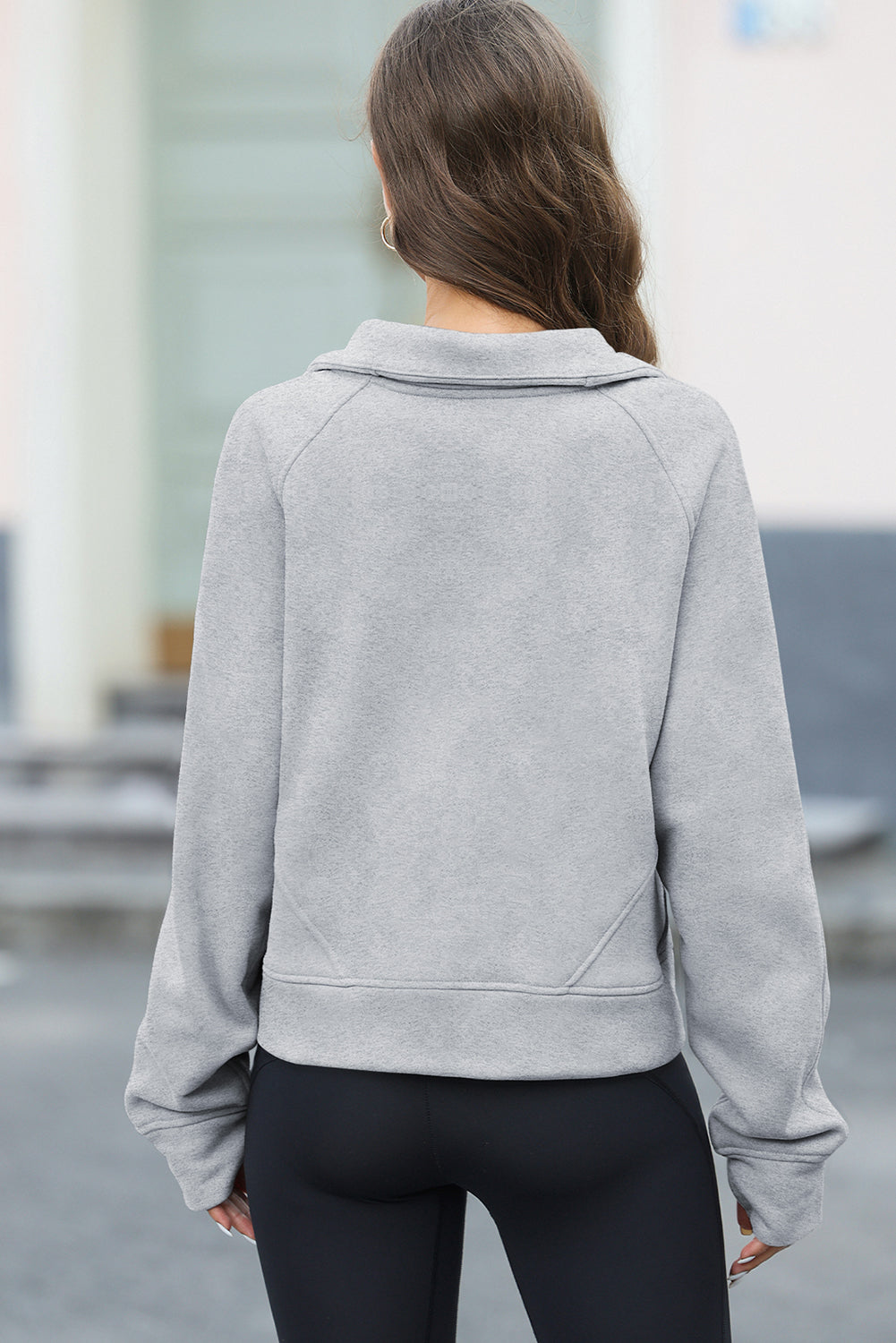 Apricot half zipper kangaroo pocket sweatshirt with thumb holes, showcasing a stylish and active design.