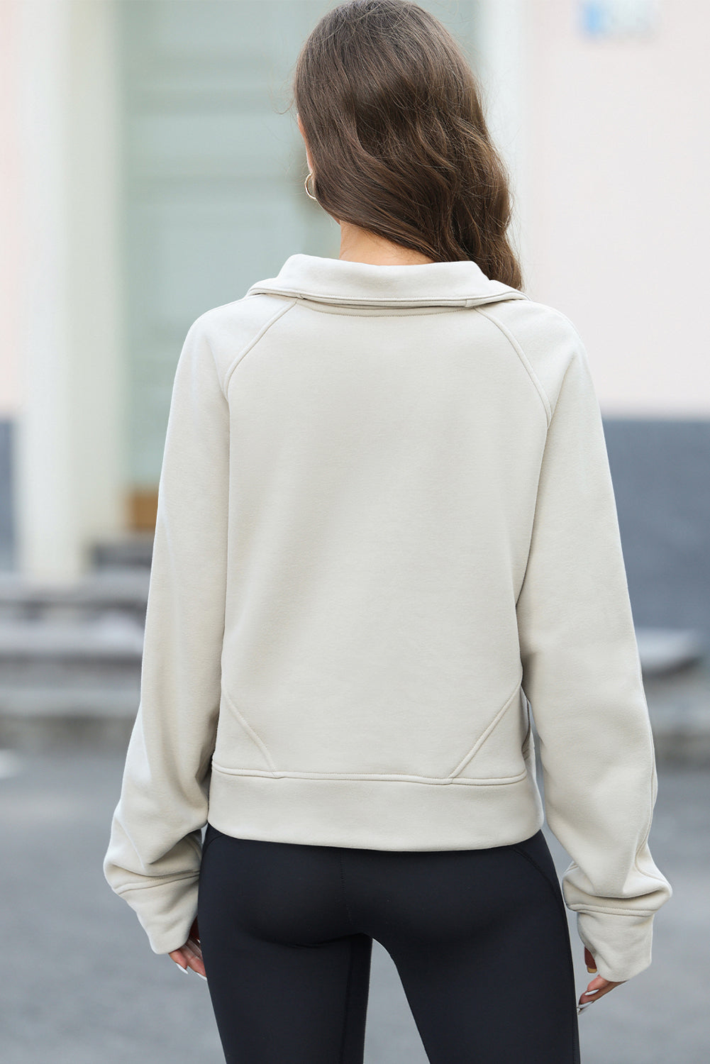 Apricot half zipper kangaroo pocket sweatshirt with thumb holes, showcasing a stylish and active design.