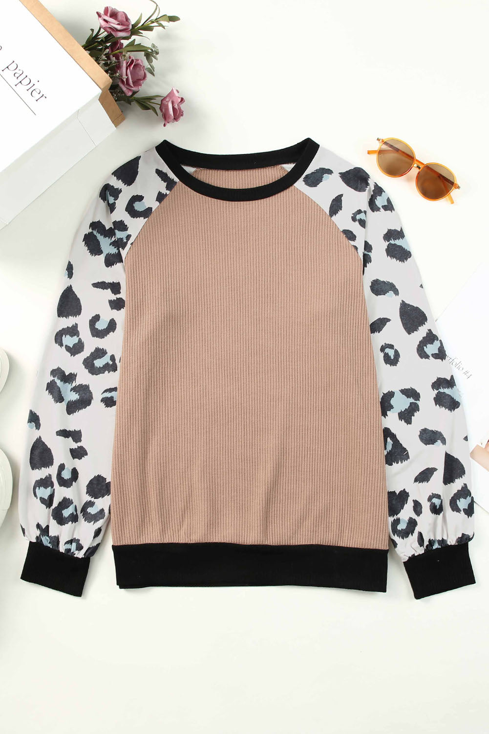 Apricot knitted pullover top with leopard print sleeves, showcasing a stylish and casual design.