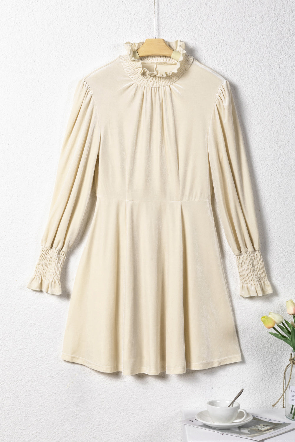 Apricot mini dress featuring a shirred collar and bubble sleeves, perfect for stylish occasions.