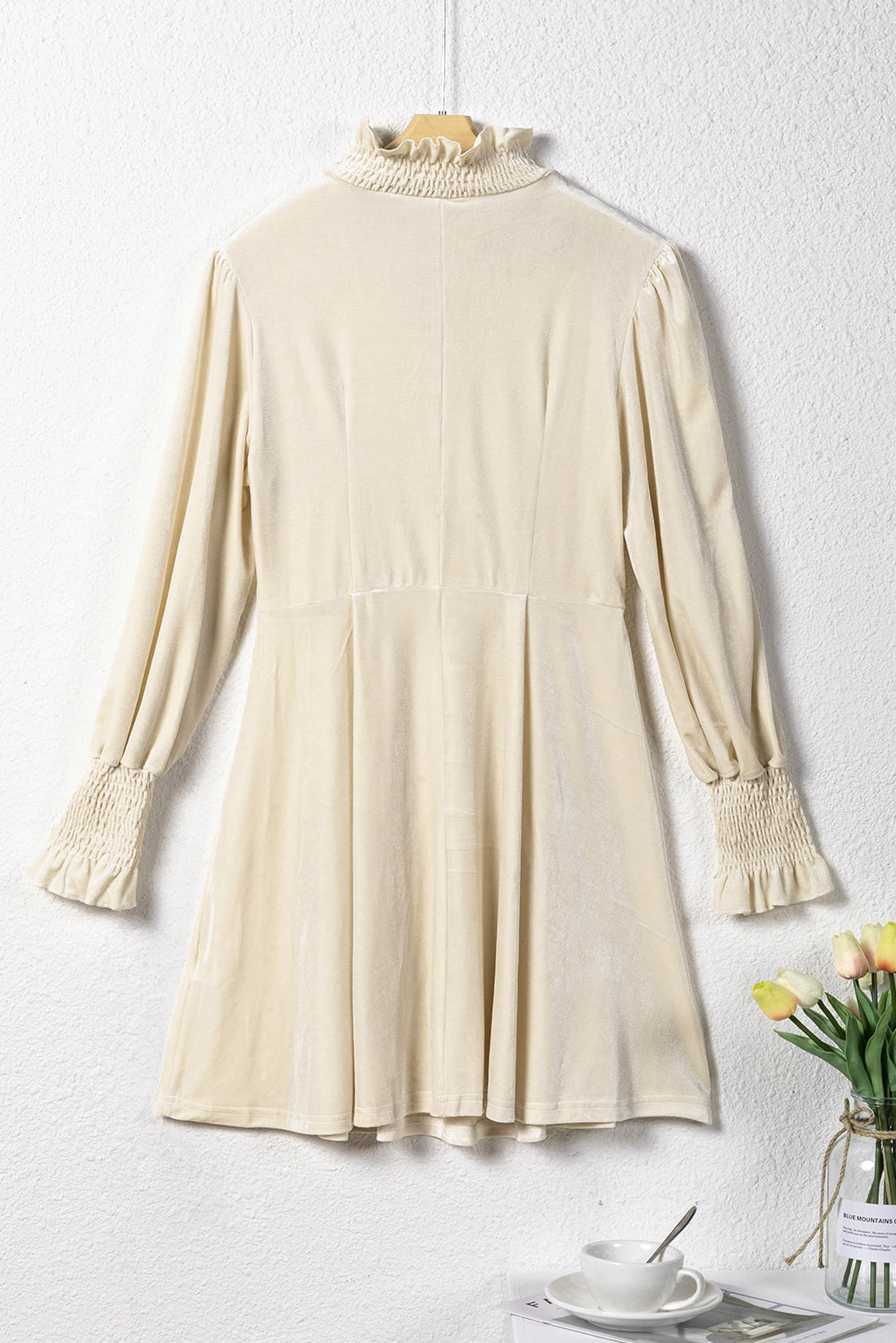 Apricot mini dress featuring a shirred collar and bubble sleeves, perfect for stylish occasions.