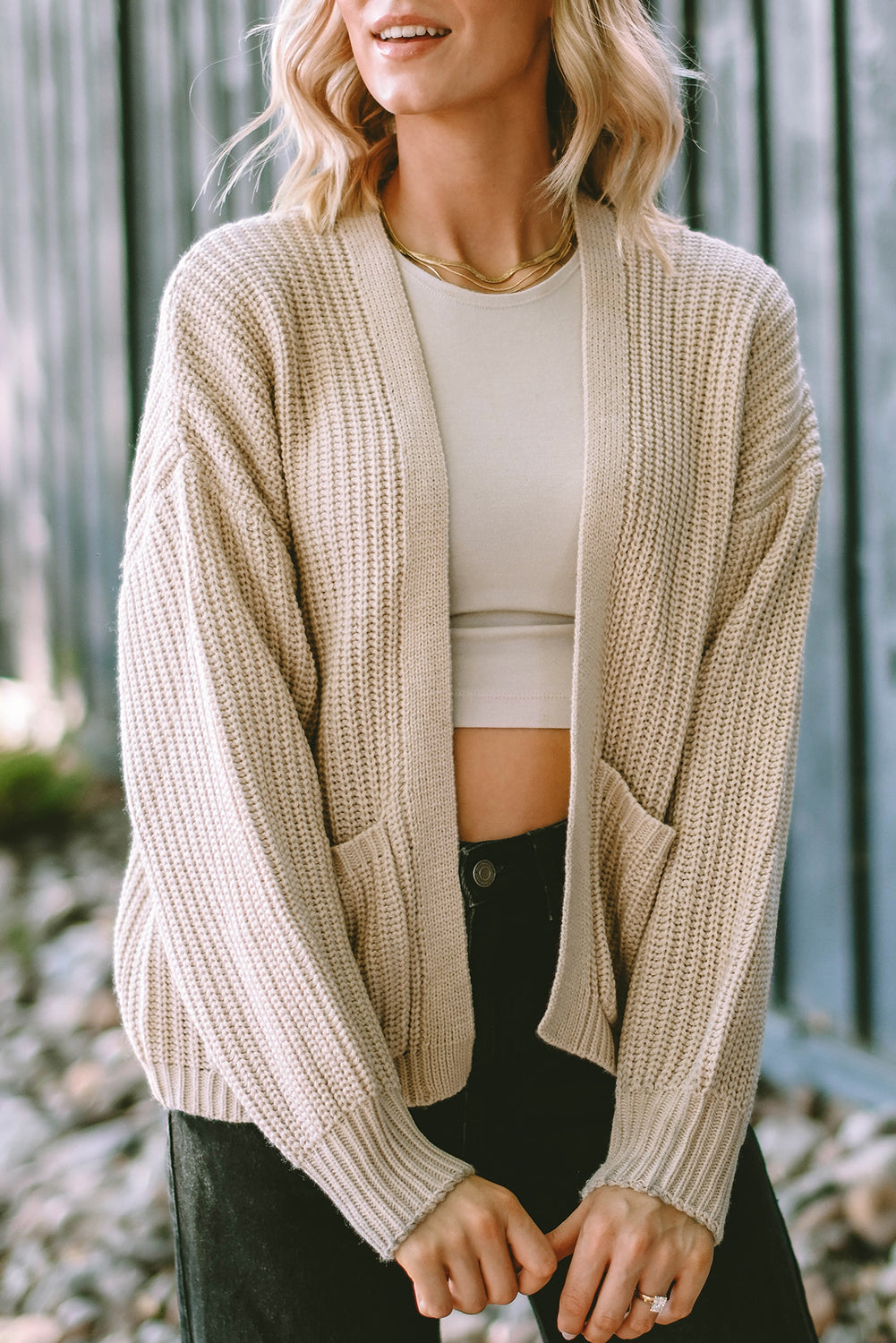 Apricot solid pocketed open short cardigan displayed on a mannequin, showcasing its stylish design and two convenient pockets.