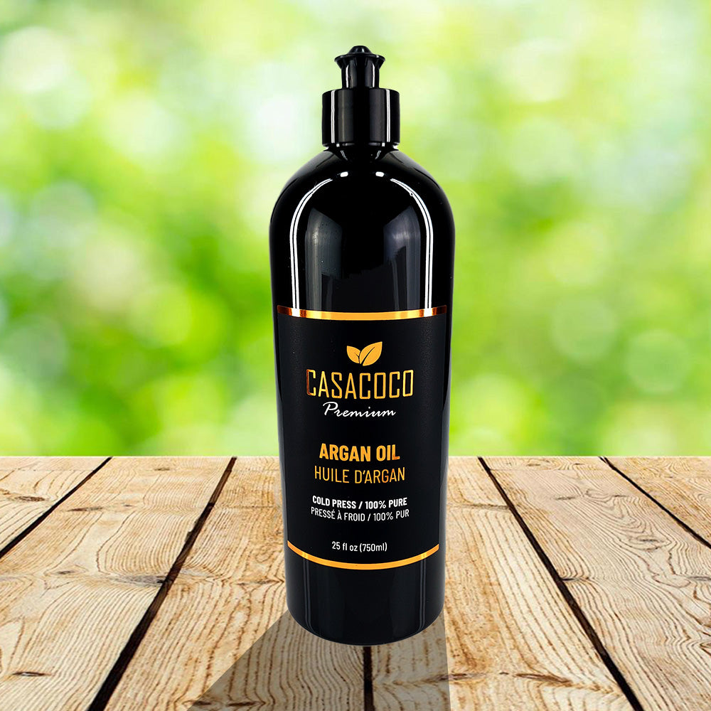 A bottle of Argan Oil with a backdrop of Argan tree nuts and leaves, showcasing its natural origins.