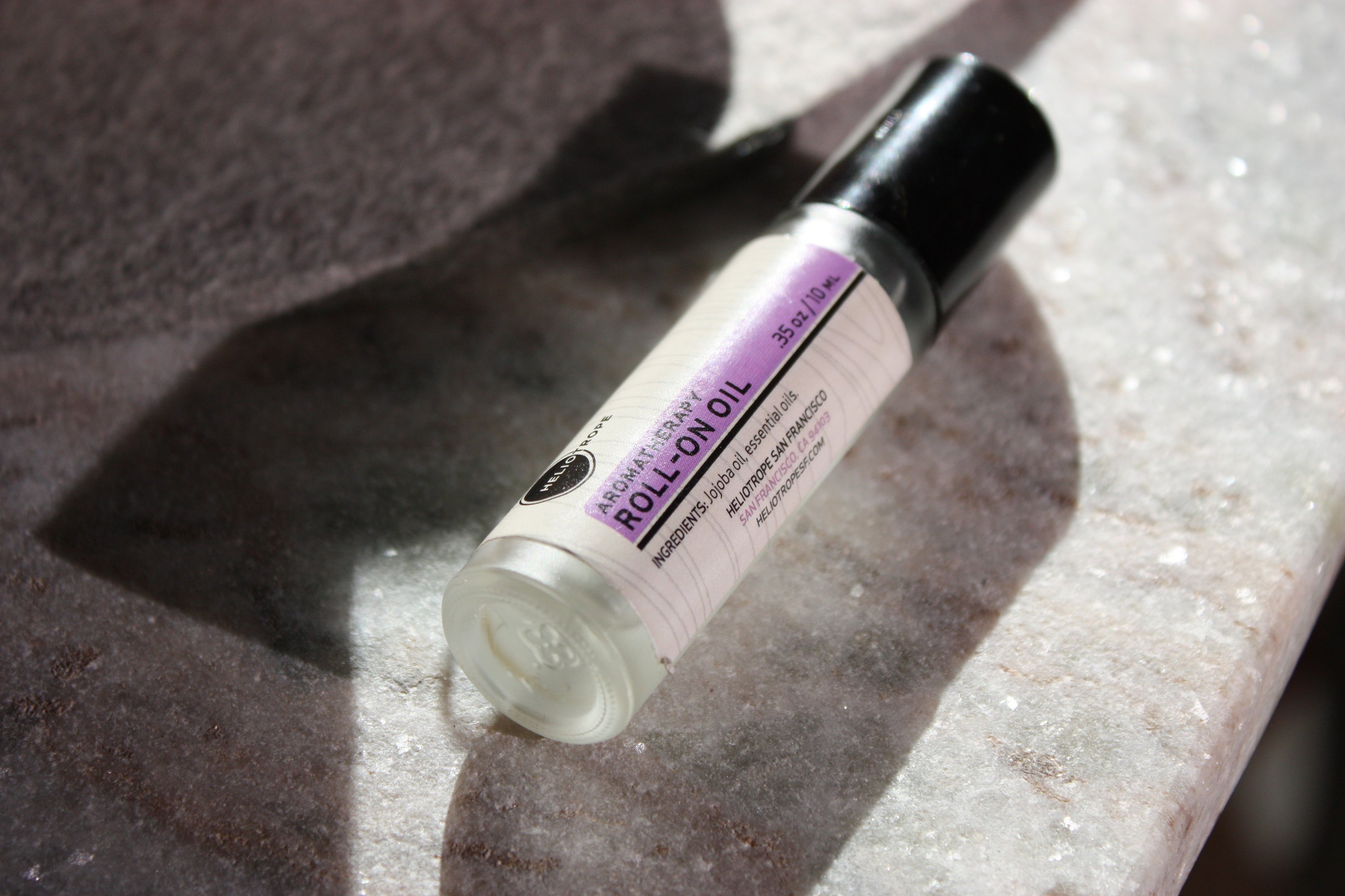 Aromatherapy Roll-On Oil in a frosted glass vial with a roll-on applicator, showcasing its natural essential oil blends.