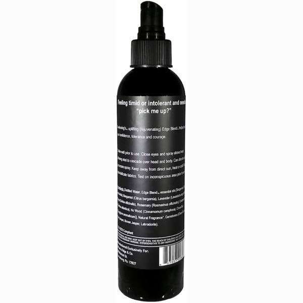 Awakening Essential Oil Spray bottle with a light mist, showcasing its elegant design and natural ingredients.