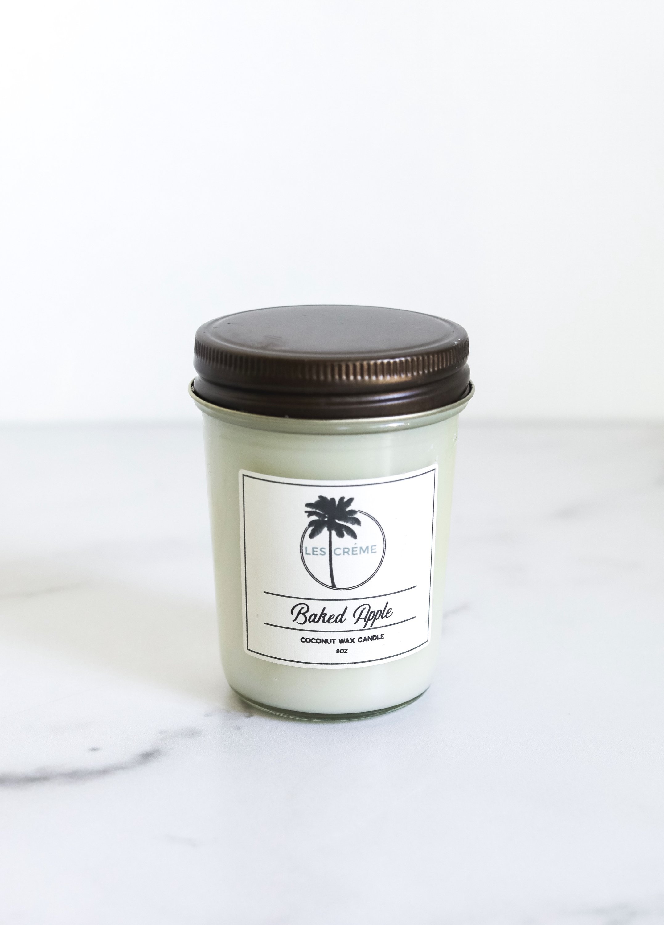 Baked Apple Scent Coconut Wax Candle in a glass jar, showcasing its warm, inviting color and natural ingredients.