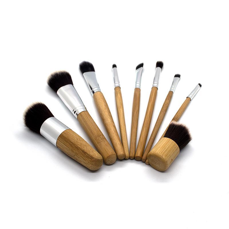 A set of 9 eco-friendly bamboo makeup brushes with soft synthetic bristles, showcasing their sustainable design and variety.