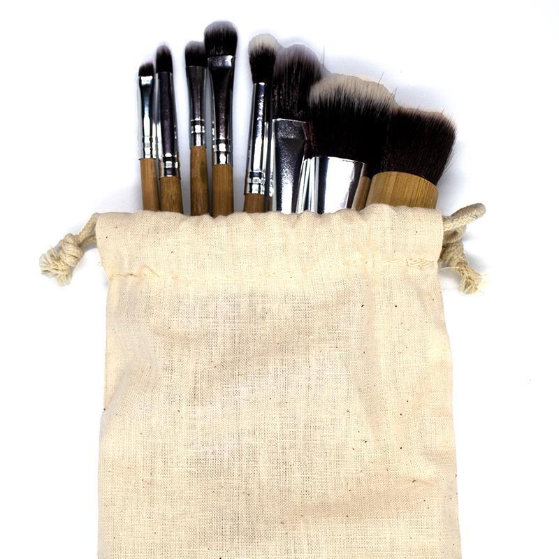 A set of 9 eco-friendly bamboo makeup brushes with soft synthetic bristles, showcasing their sustainable design and variety.