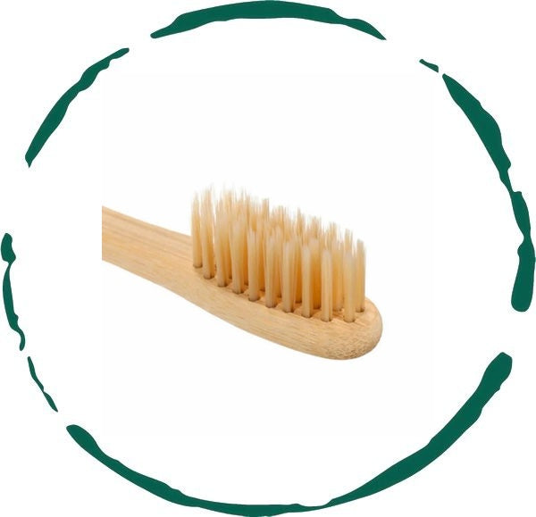 Eco-friendly bamboo toothbrush with soft nylon bristles, featuring a non-slip handle and a delicate design.