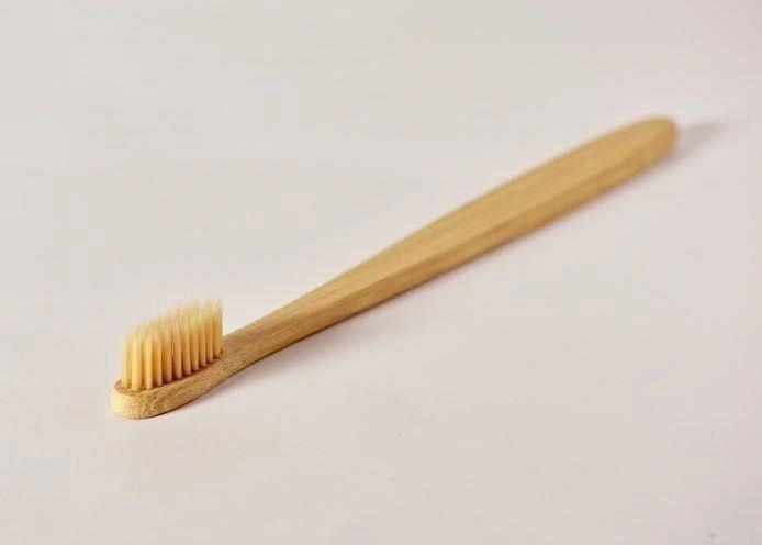 Eco-friendly bamboo toothbrush with soft nylon bristles, featuring a non-slip handle and a delicate design.