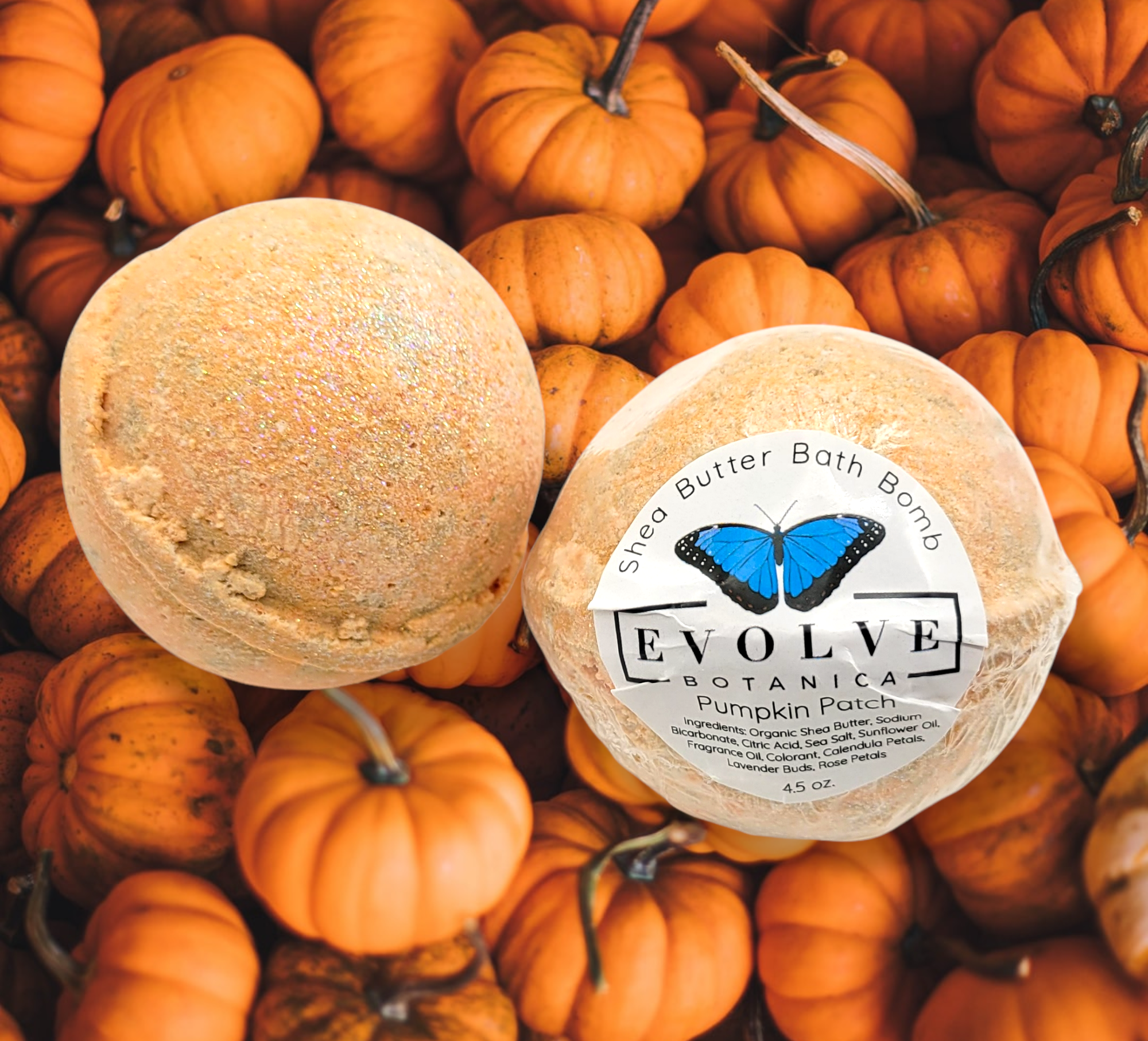 A vibrant Pumpkin Patch Bath Bomb with autumn colors, featuring pumpkin and spice motifs, resting on a wooden surface.